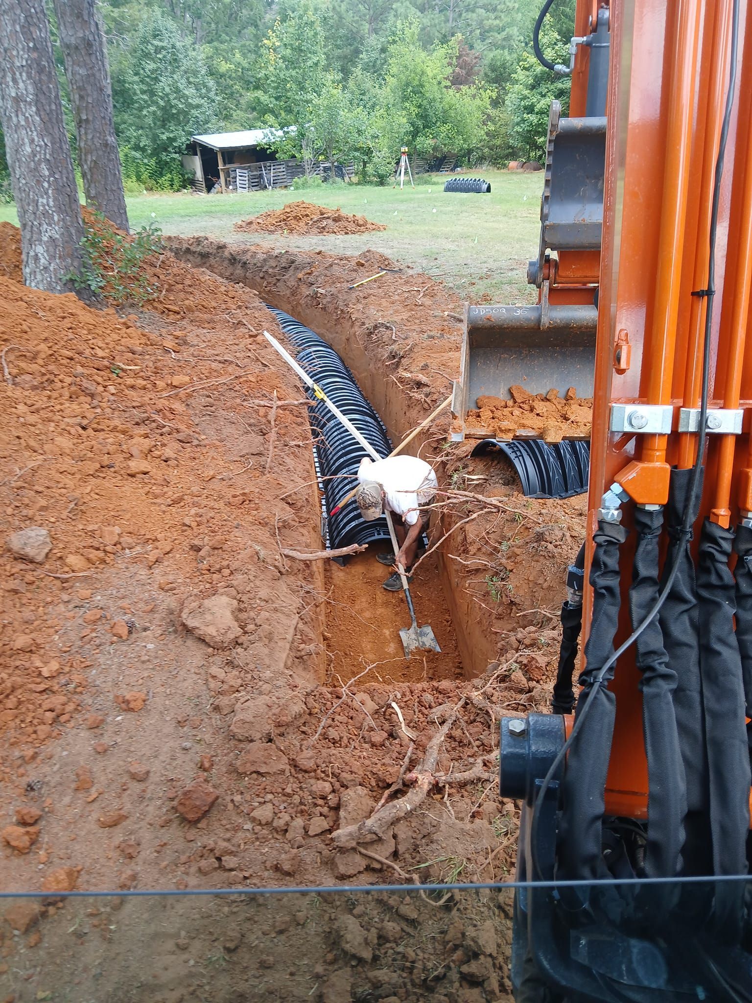 A man is digging a hole in the ground with a shovel.