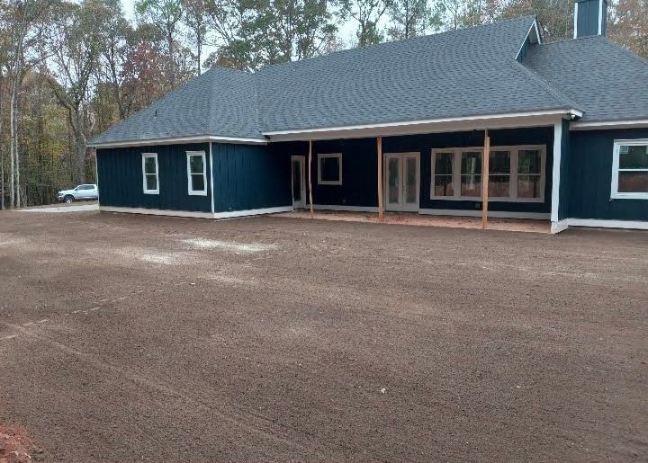 A blue house with a black roof and white trim