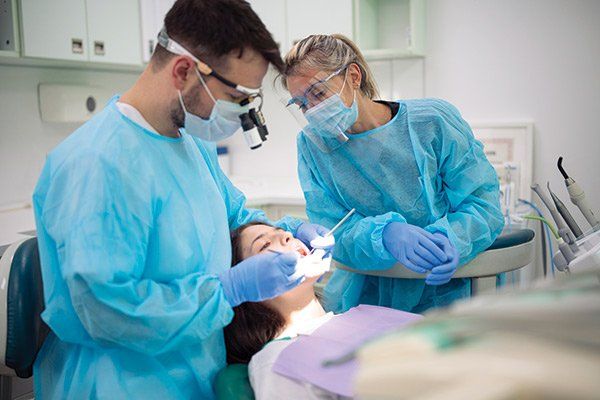 Dentist Examining Patient Mouth — Albuquerque, NM — New Mexico Endodontic Specialists