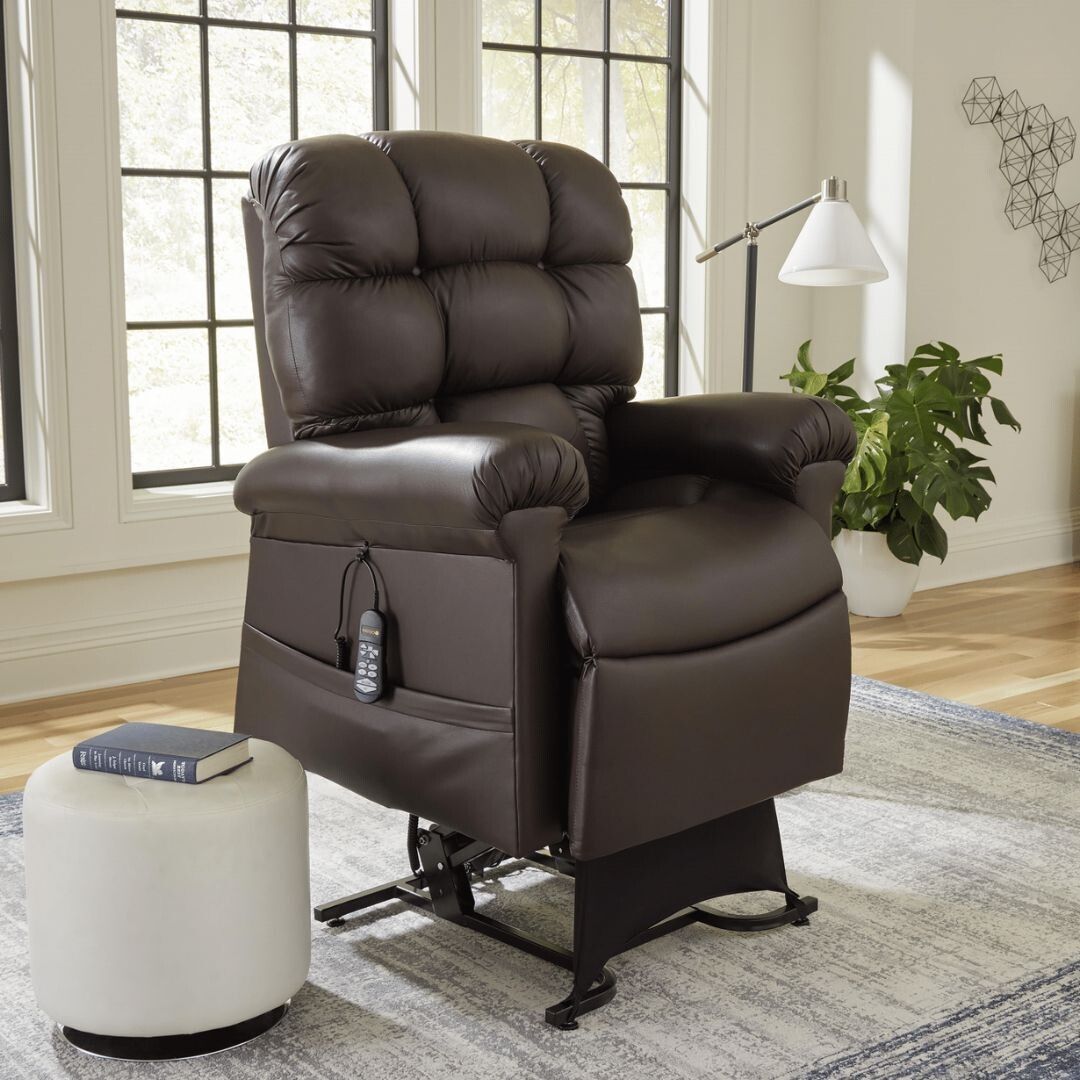 A brown leather recliner is sitting on a rug in a living room.