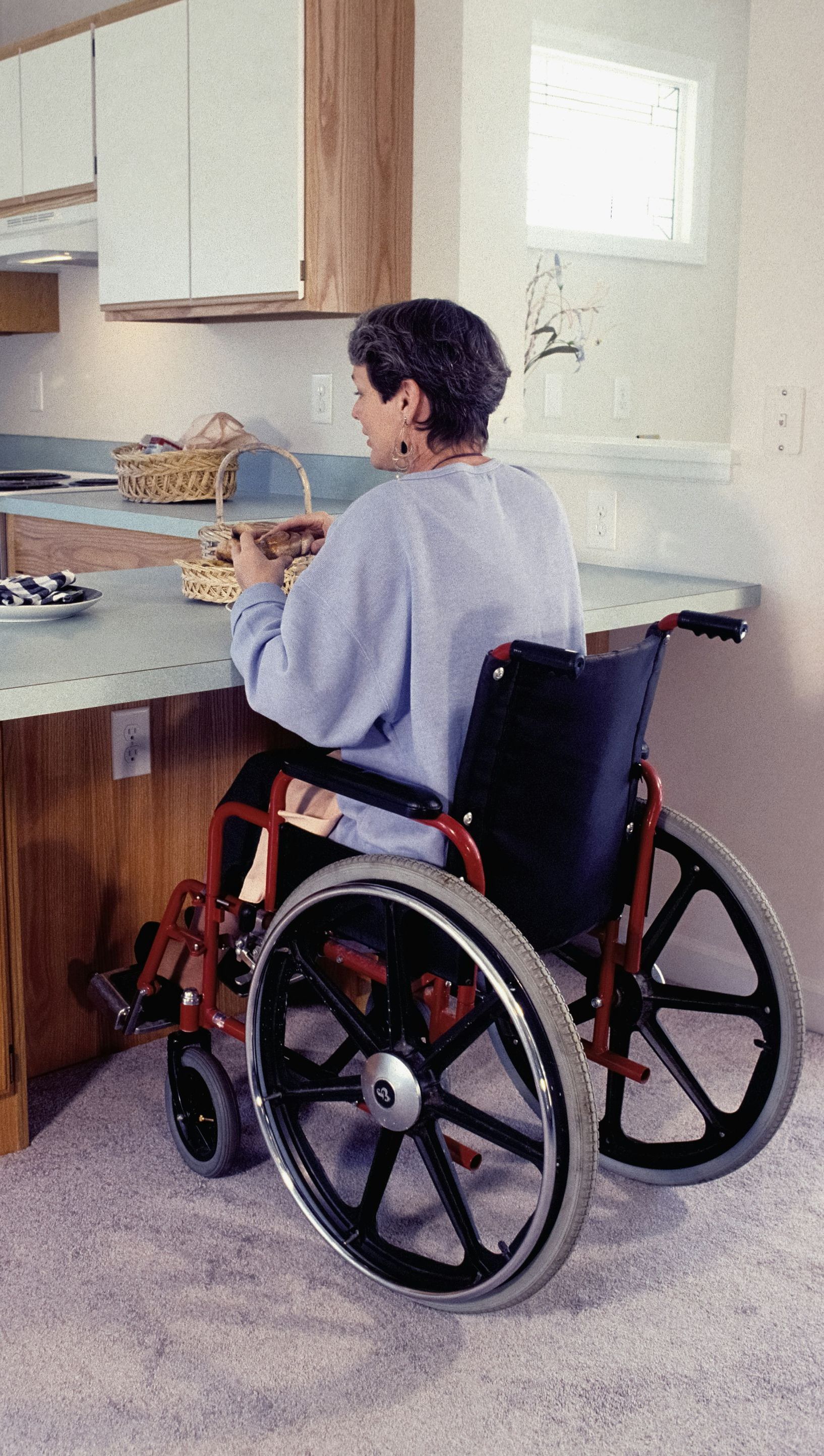 woman in wheelchair at kitchen counter