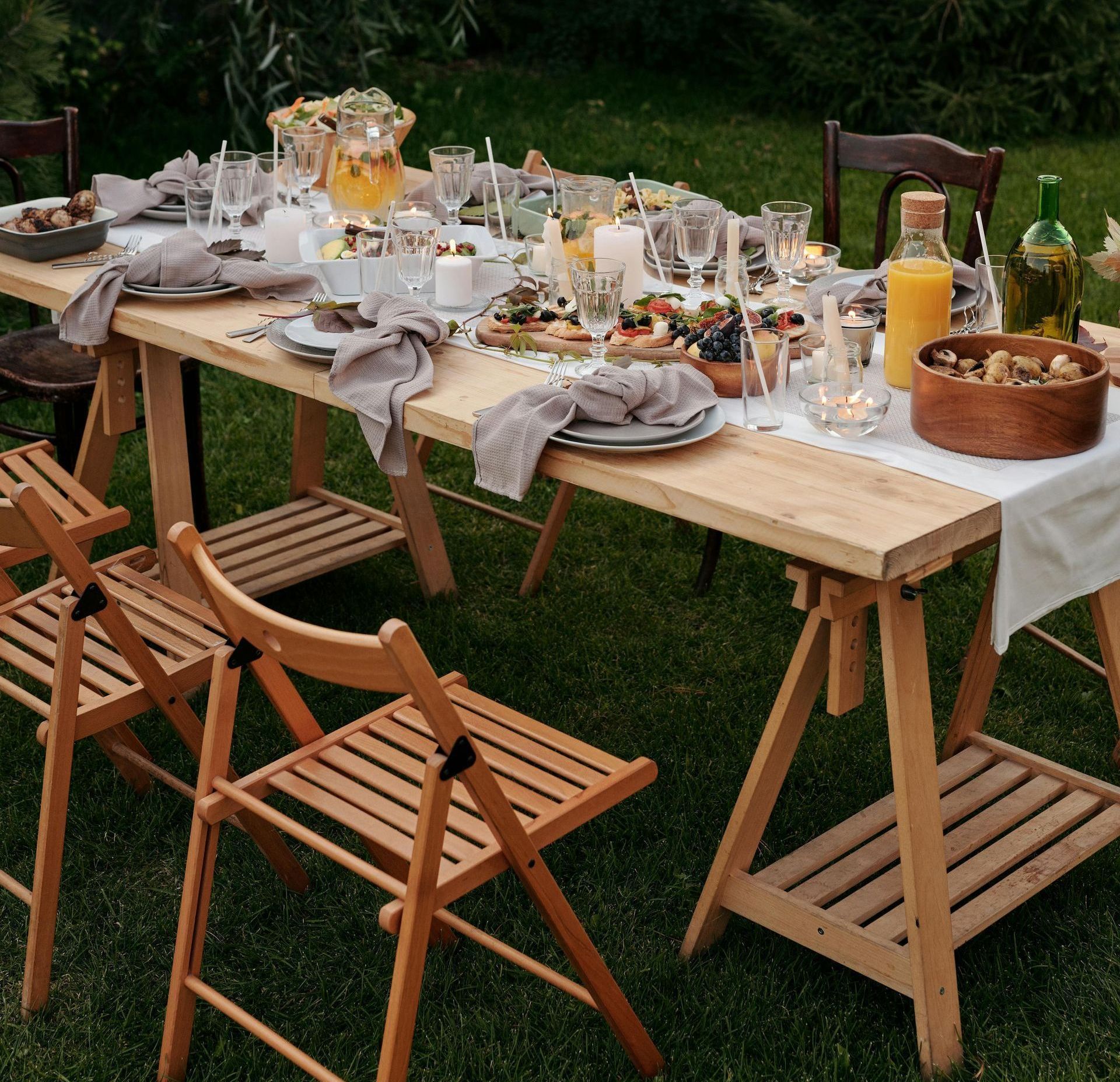 A wooden table with plates and glasses on it