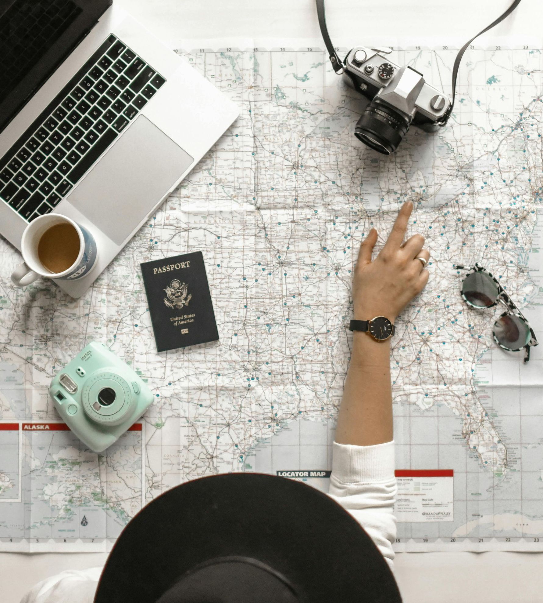 A person is pointing at a map on a table