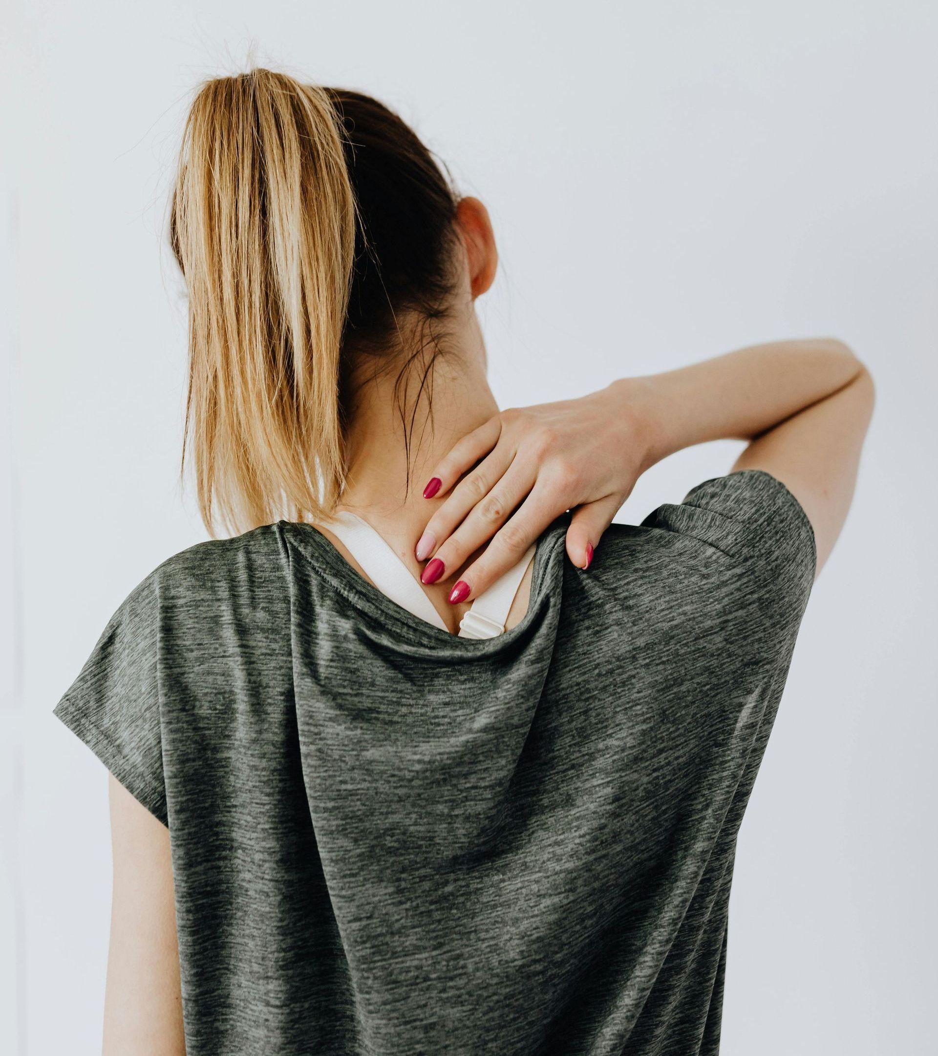 woman holds an injured neck