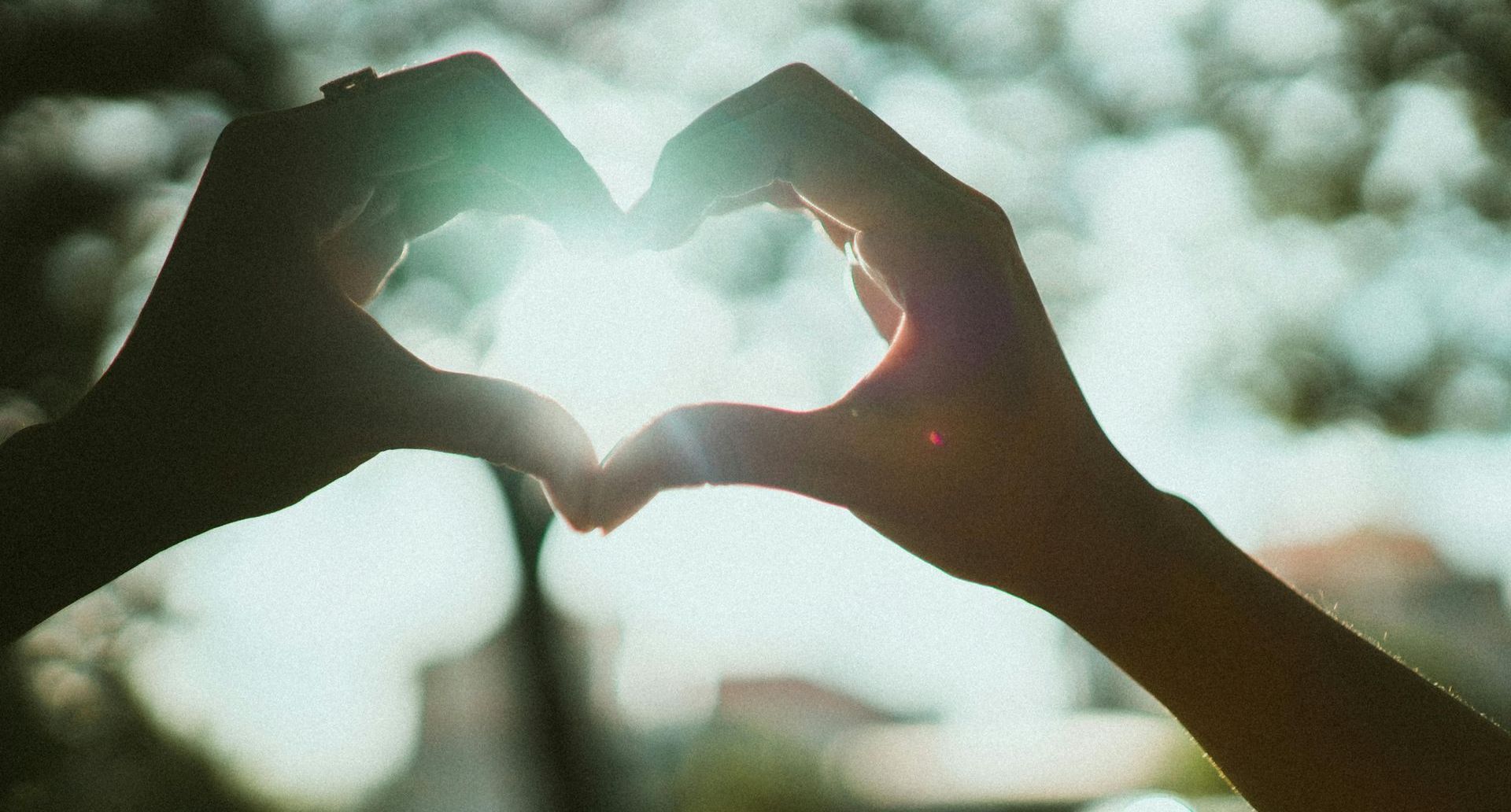 a person making a heart with their hands