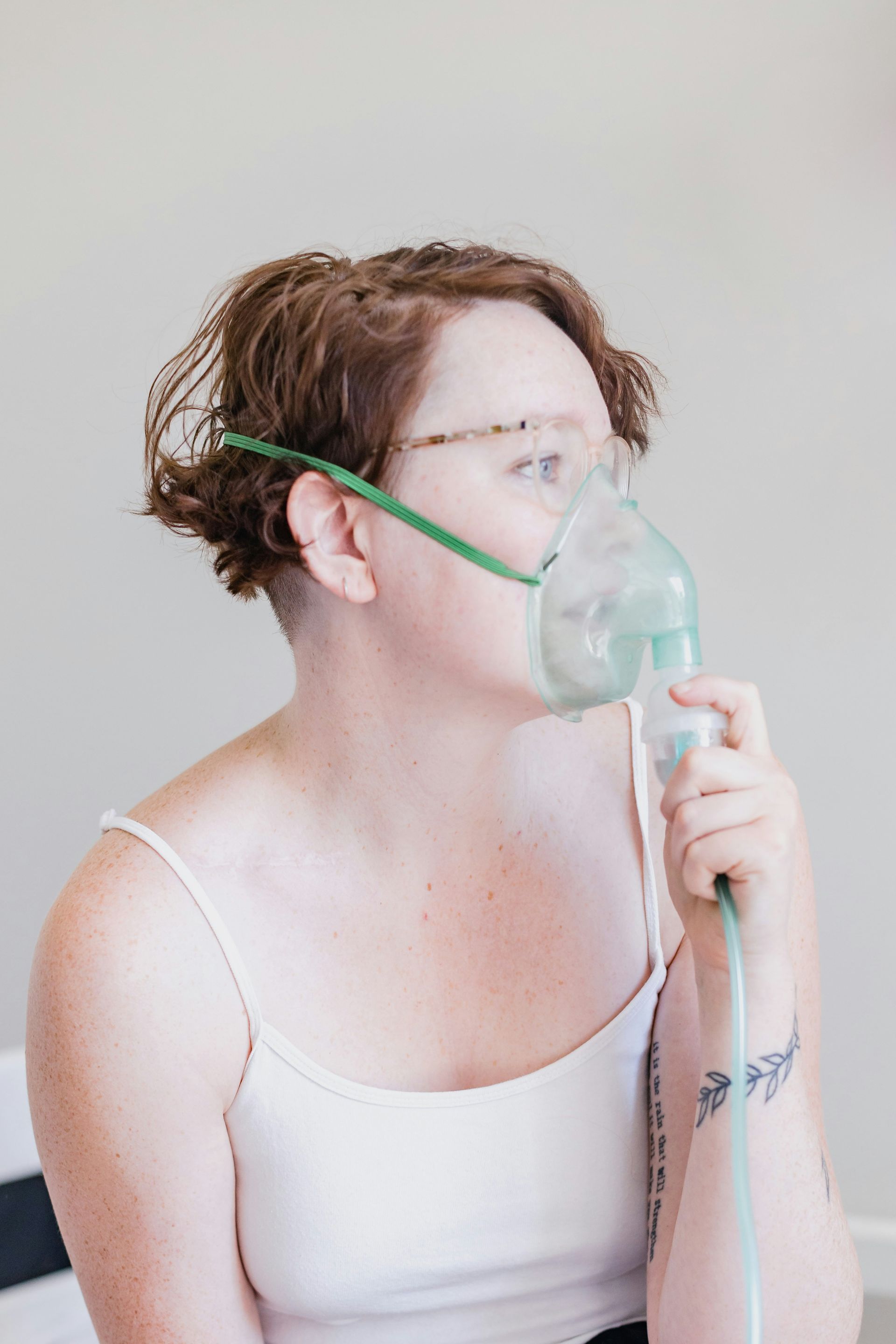 A woman is wearing an oxygen mask on her face.