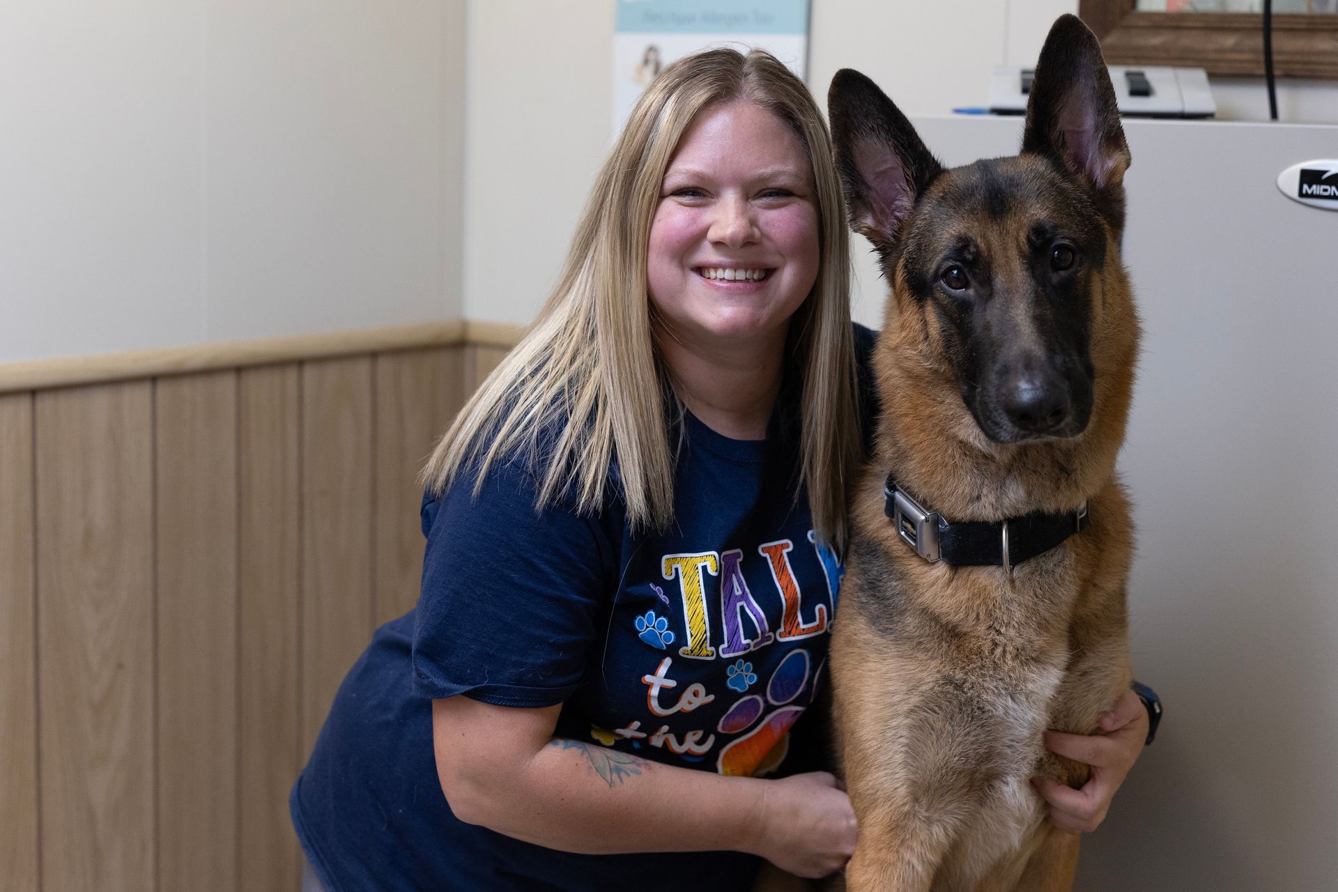 A Woman is Holding a German Shepherd Dog in her Arms — Elyria, OH — Elyria Animal Hospital