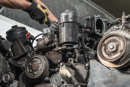 A close up of the engine of a truck with the hood open.