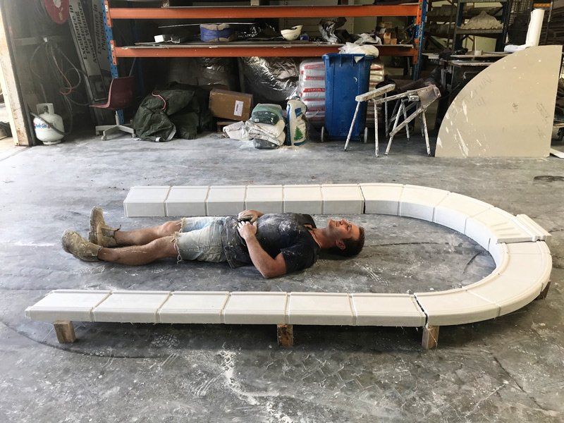 Worker Beside Archway — Manufacturing Cornices in Logan Village, QLD