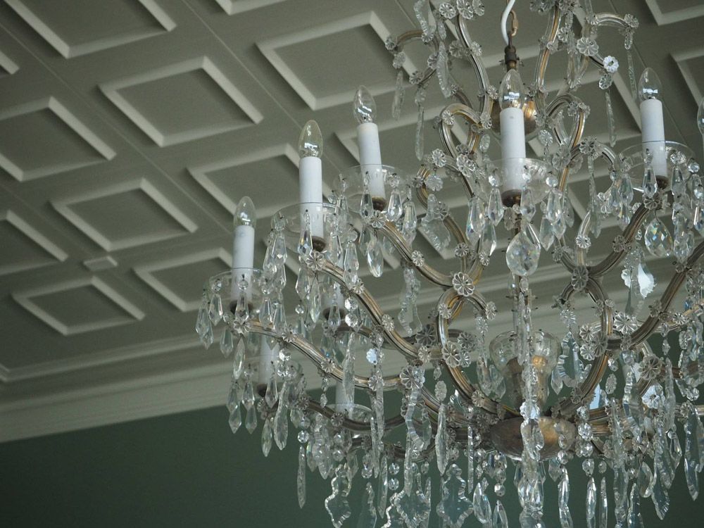 A chandelier is hanging from the ceiling in a room