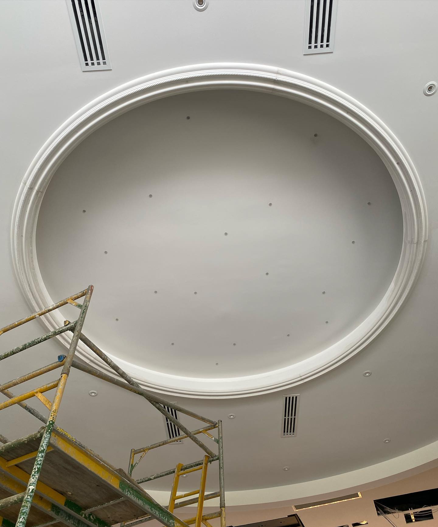 A round ceiling with a scaffolding in front of it.