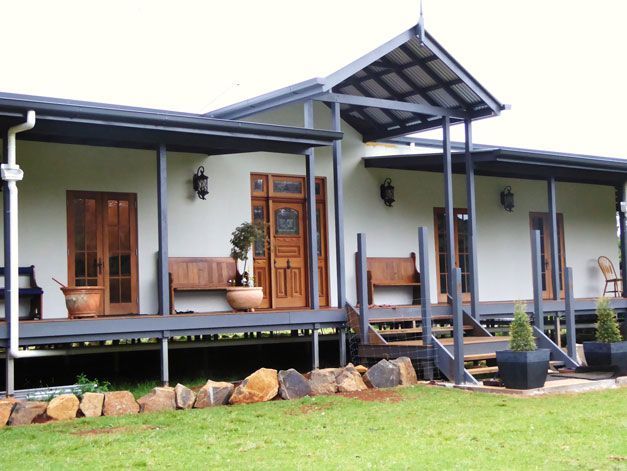 A large white house with a porch and stairs