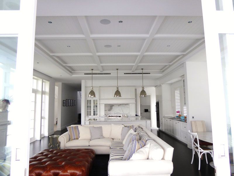 A living room with a couch and ottoman in it