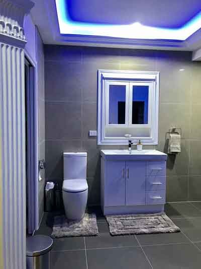 Bathroom with cabinet and toilet — Manufacturing Cornices in Logan Village, QLD