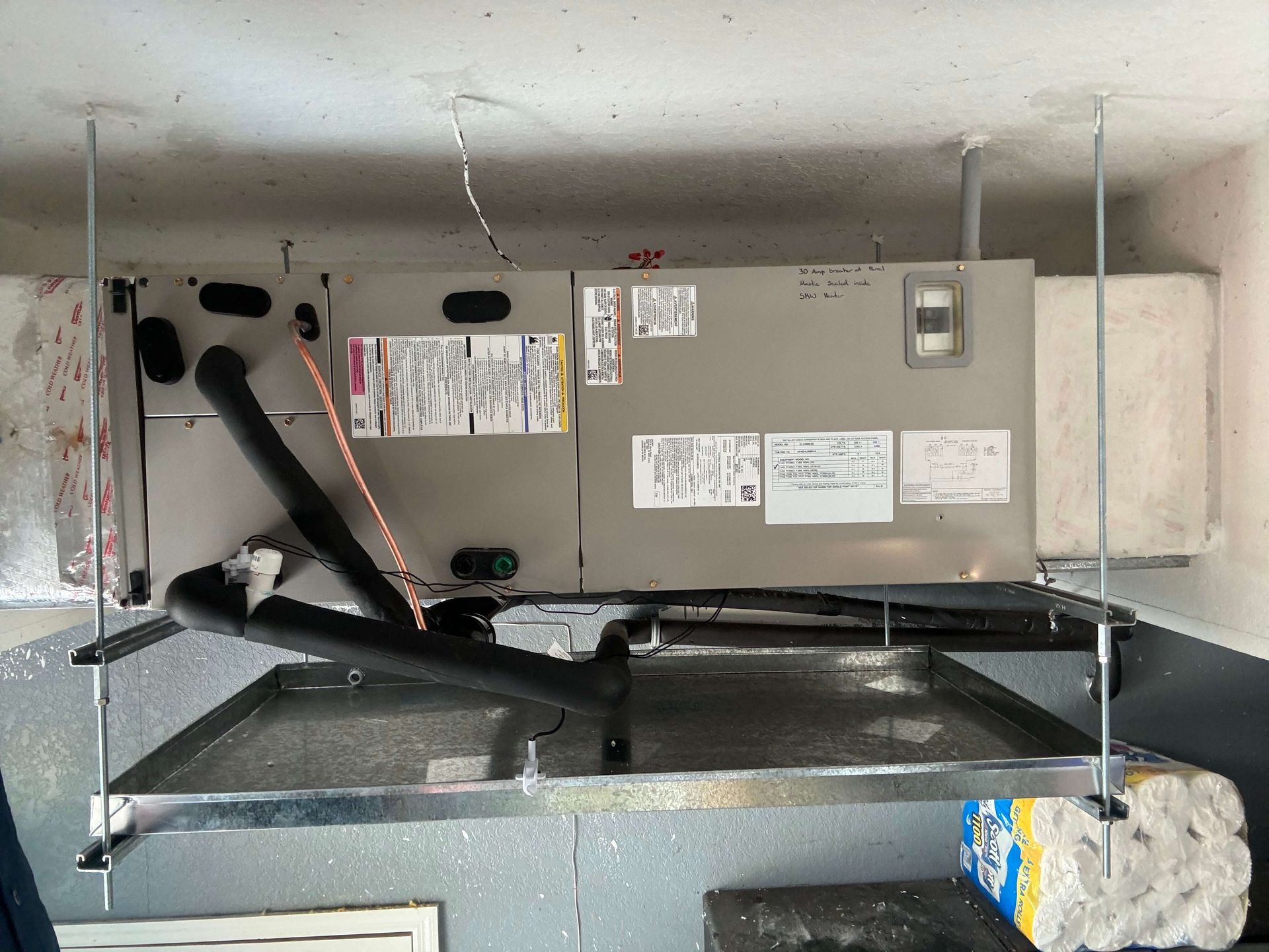 An air conditioner is hanging from the ceiling in a room.