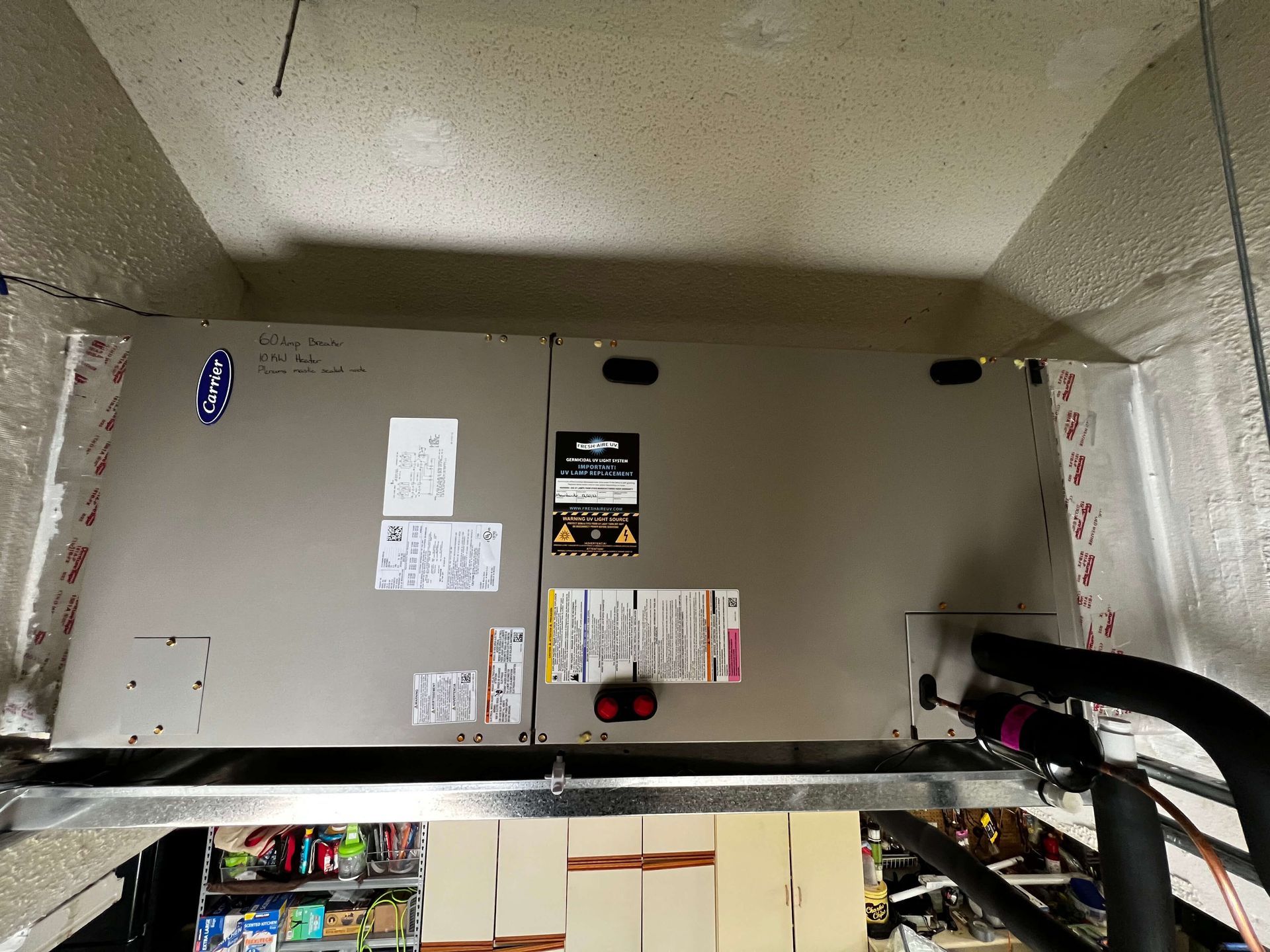A ceiling mounted air conditioner is sitting in a corner of a room.