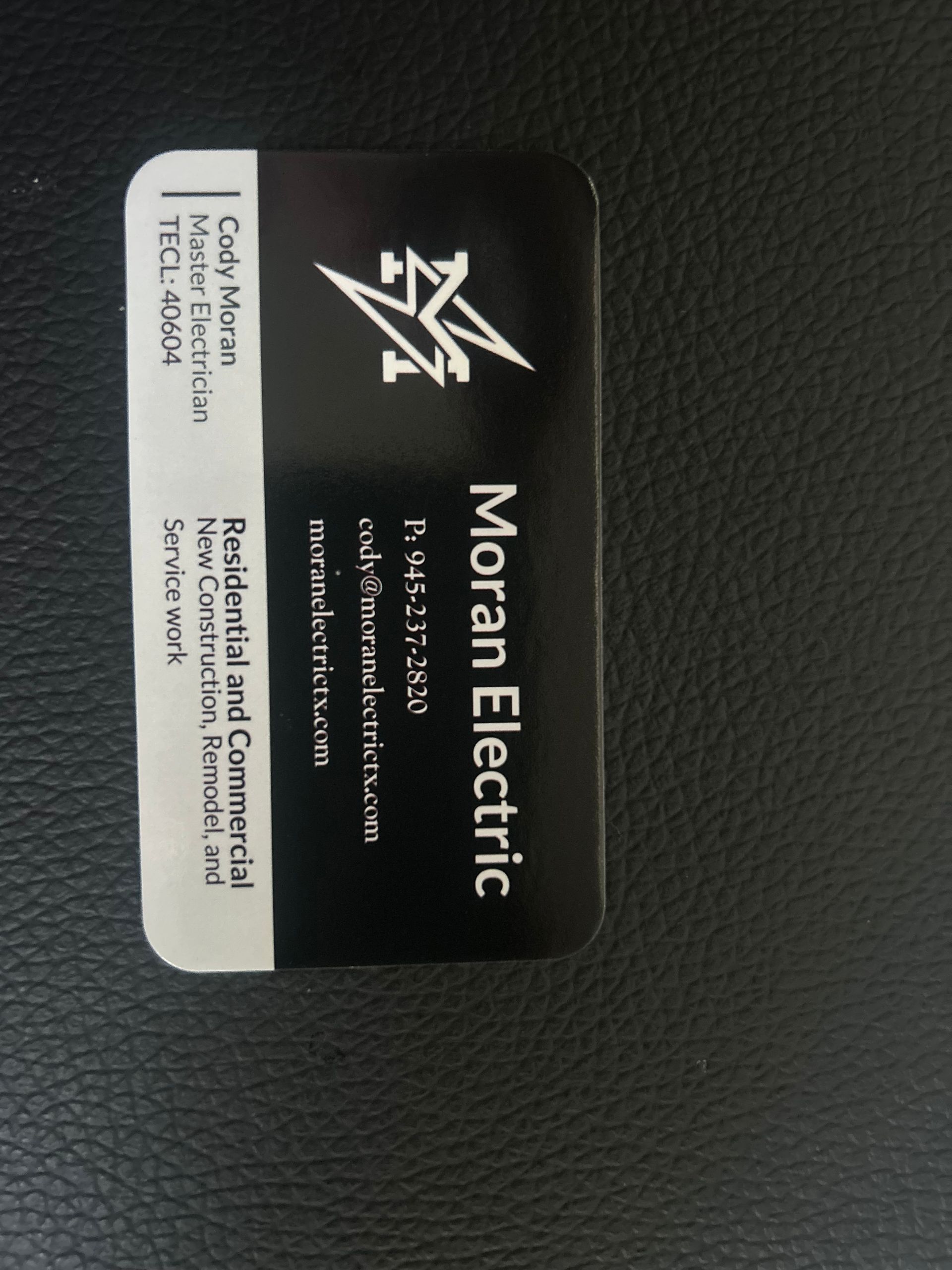 Business card for Moran Electric, black and white design. Name Cody Moran, contact information provided.
