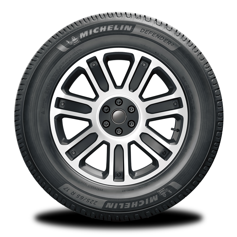 A close up of a michelin tire on a white background.
