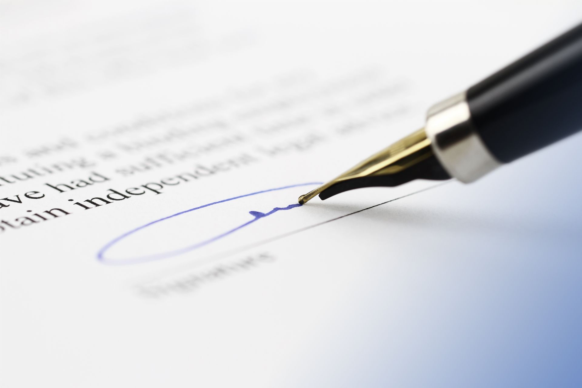 A close up of a pen signing a document