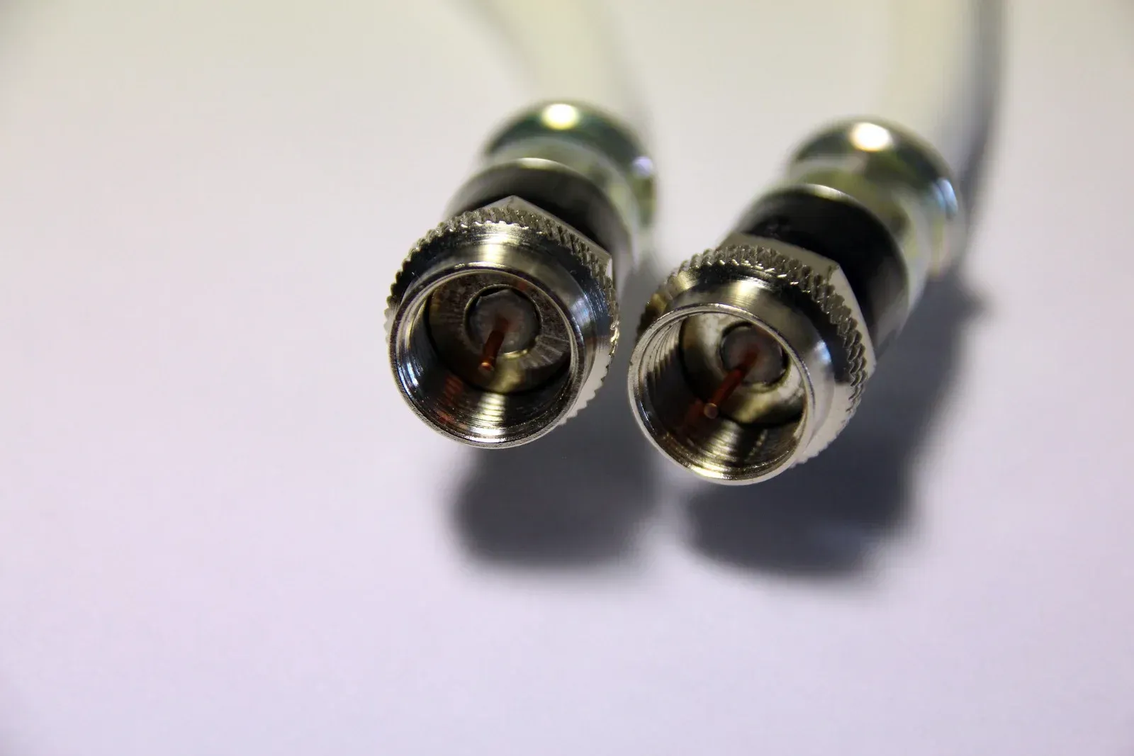 A close up of two connectors on a white surface