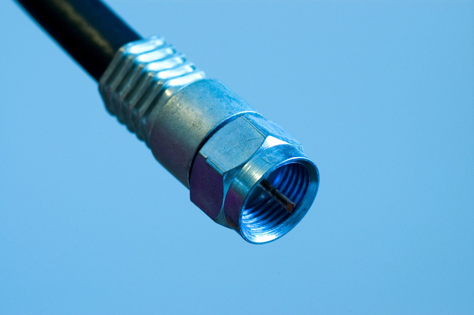 A close up of a cable connector on a blue background.