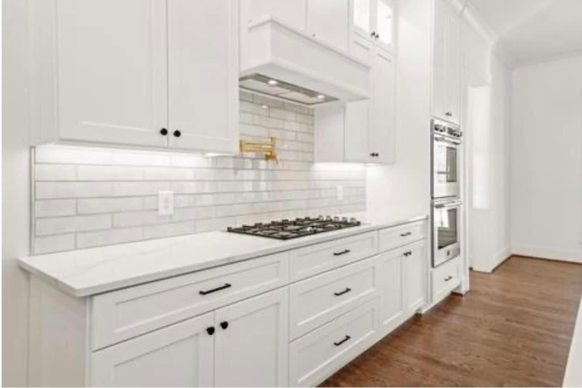 Kitchen with white cabinets and hardwood flooring