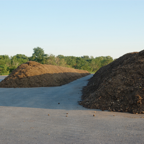 A pile of dirt sits on the side of a road