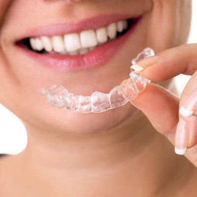 woman about to put on invisalign tray