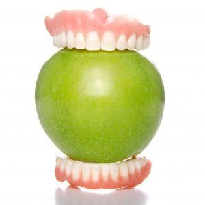 dentures biting apple