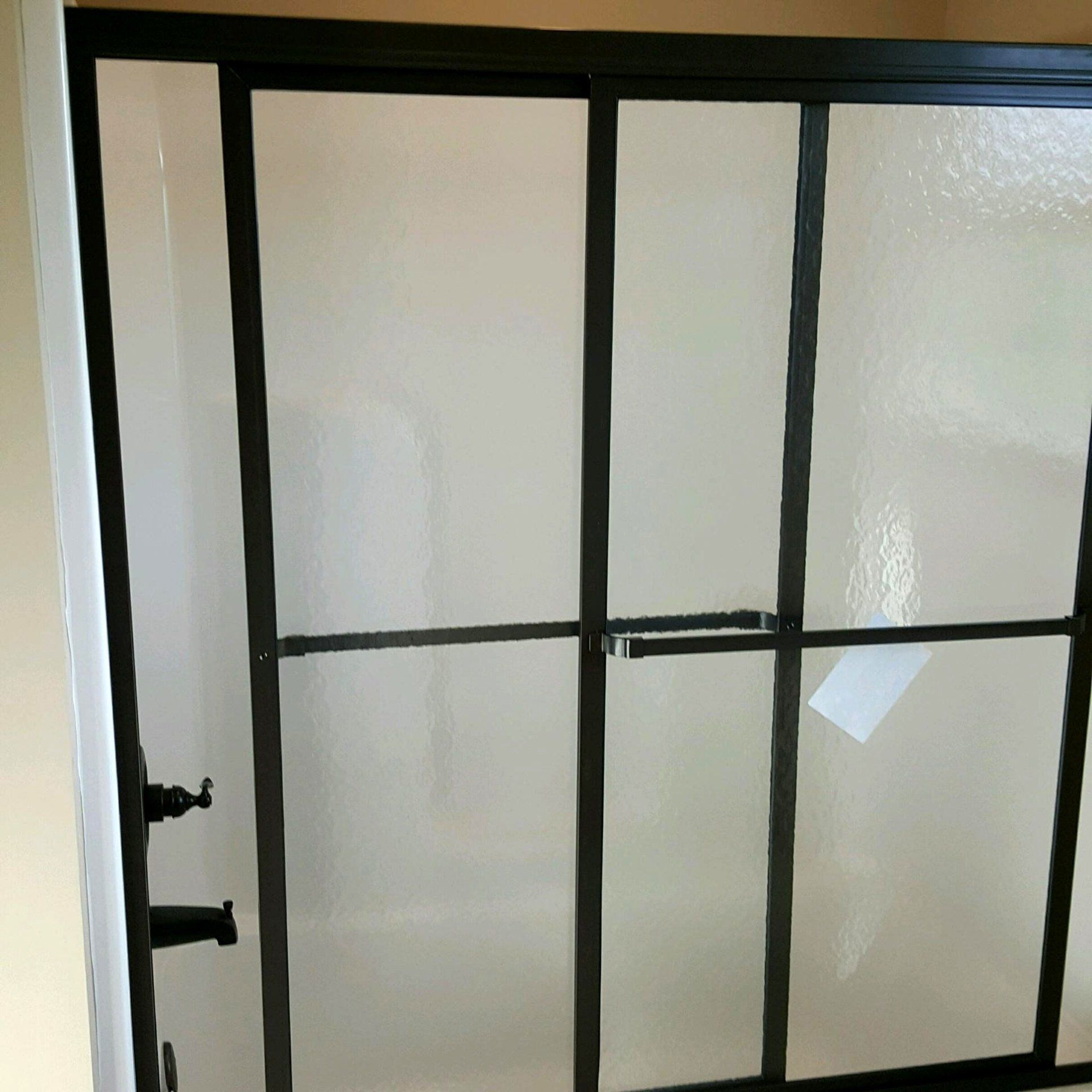 Tankless Water Heaters For Sale — Black Opaque Shower Door in Florence, AL