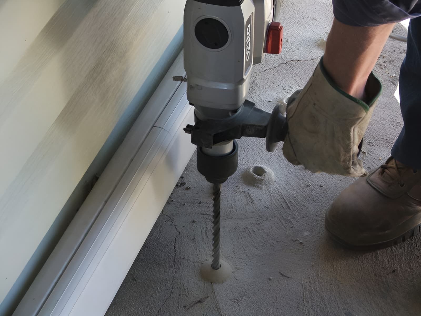 A Person is Using a Makita Drill to Drill a Hole in a Wall — Audy Geiszler Pest Control in Proserpine, QLD