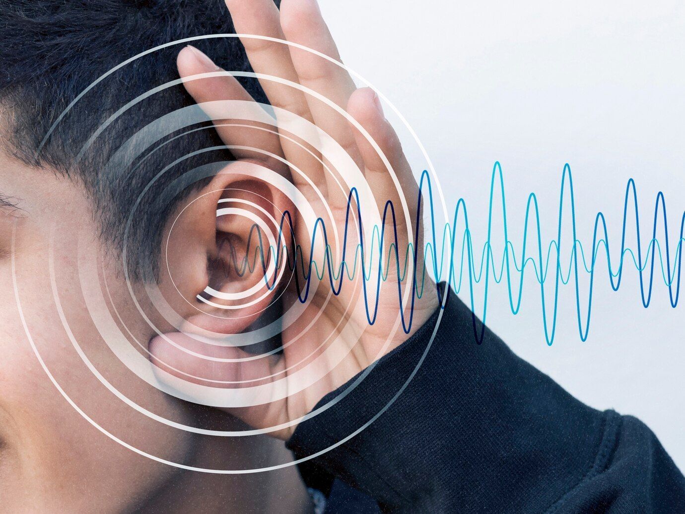 A man is listening to a sound wave in his ear.