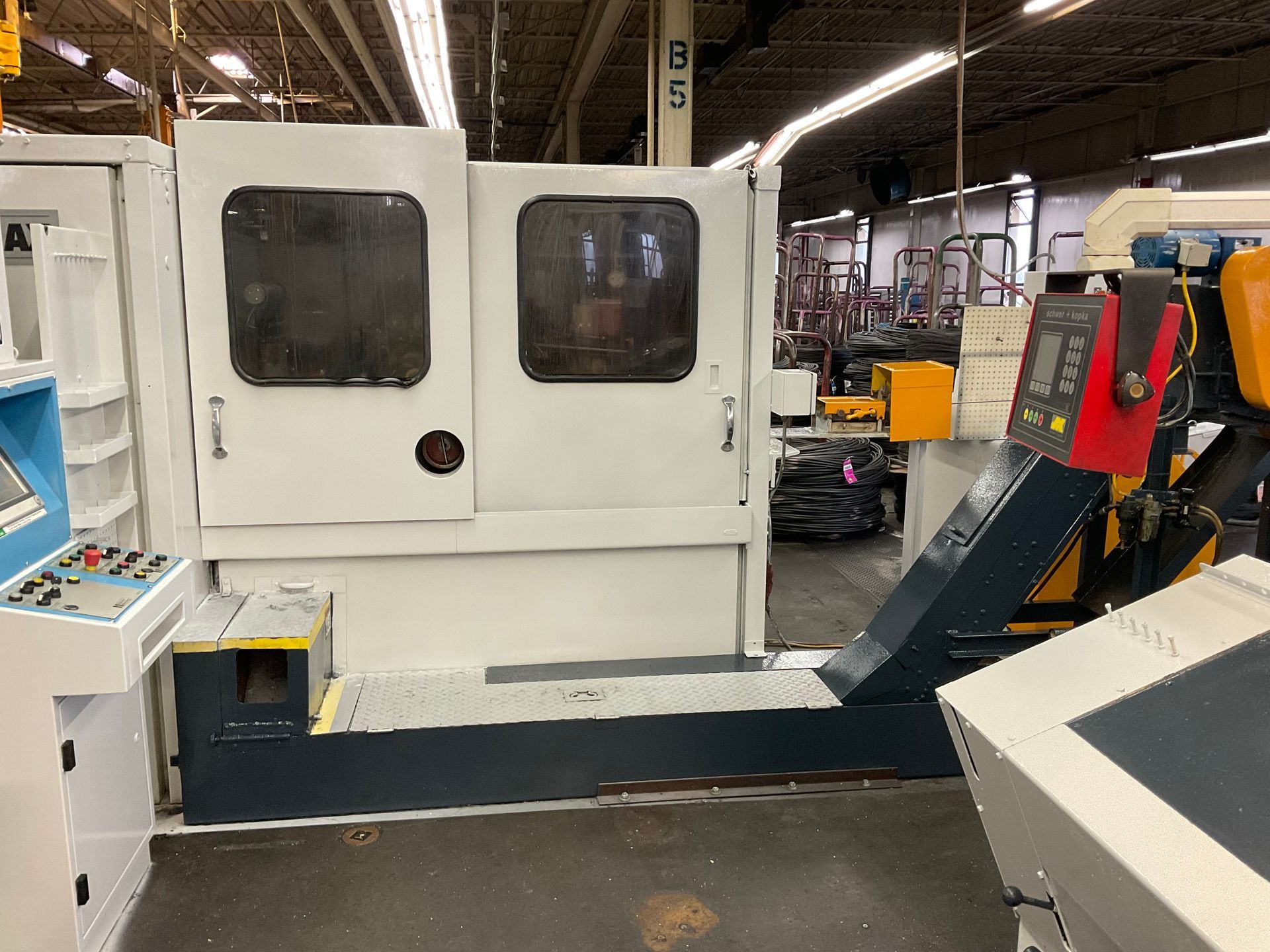 A machine is sitting in a room in a factory.