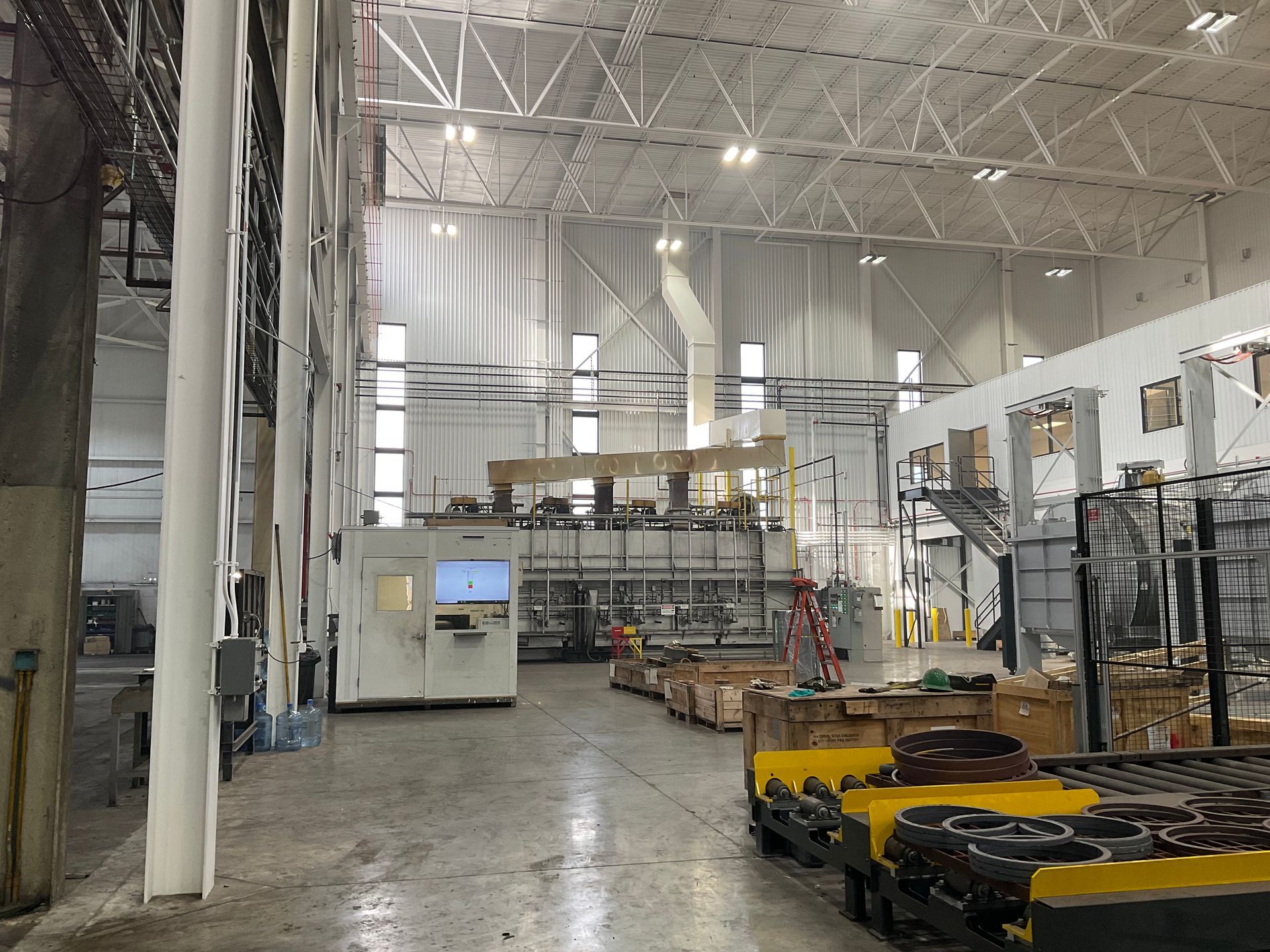 A large warehouse filled with lots of boxes and machinery.