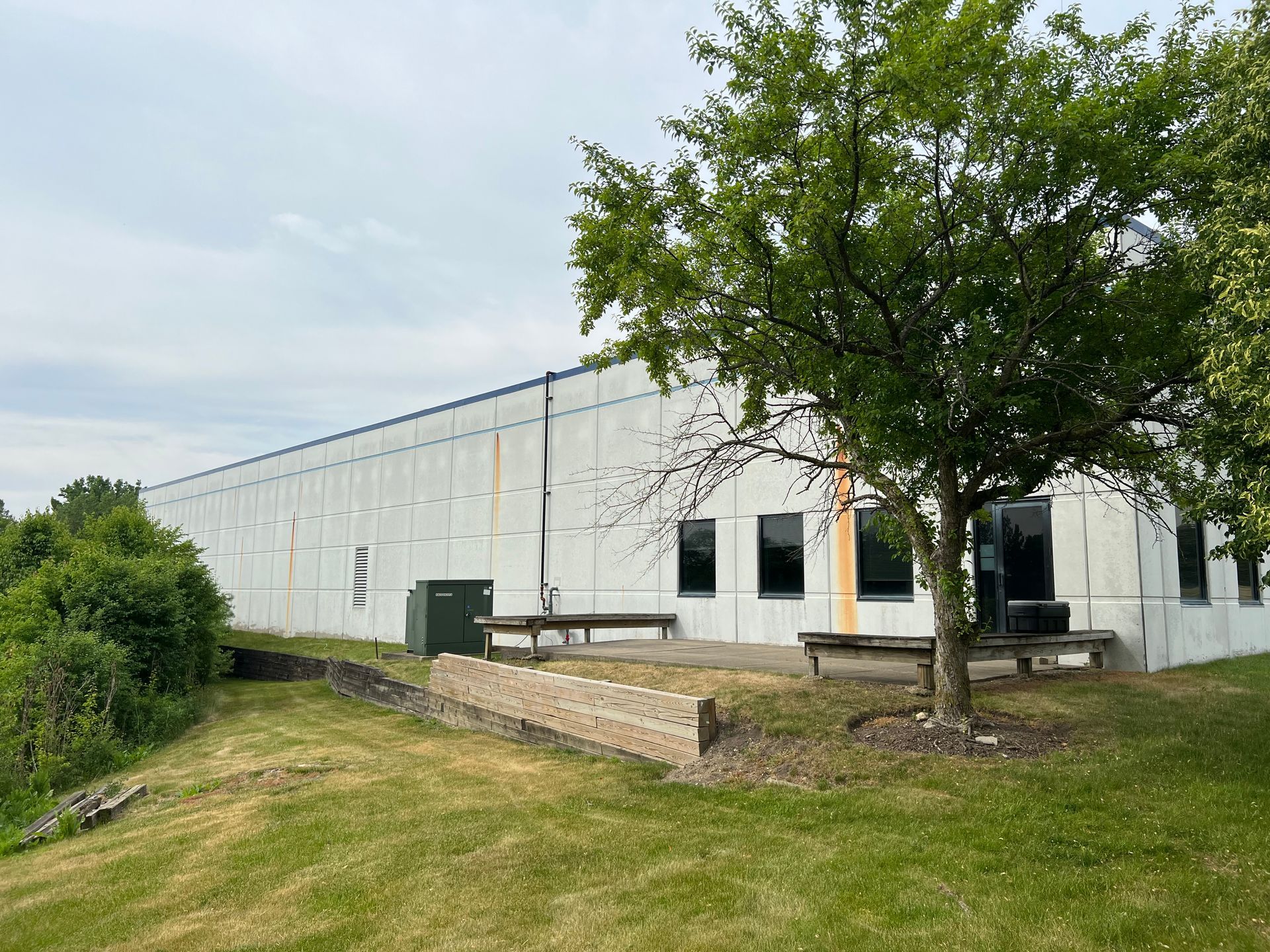 A large white building with a tree in front of it.