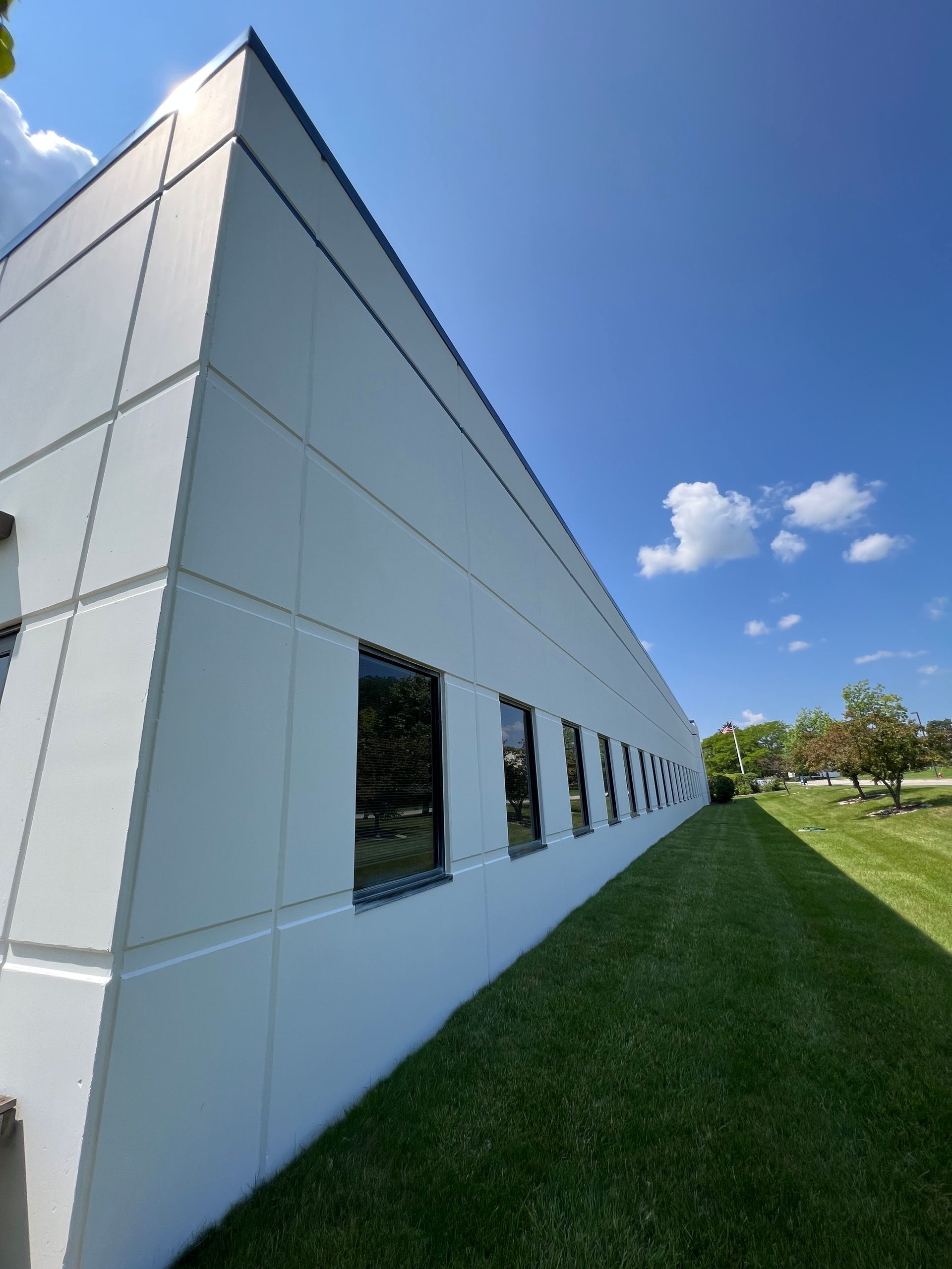 A white building with a blue sky in the background