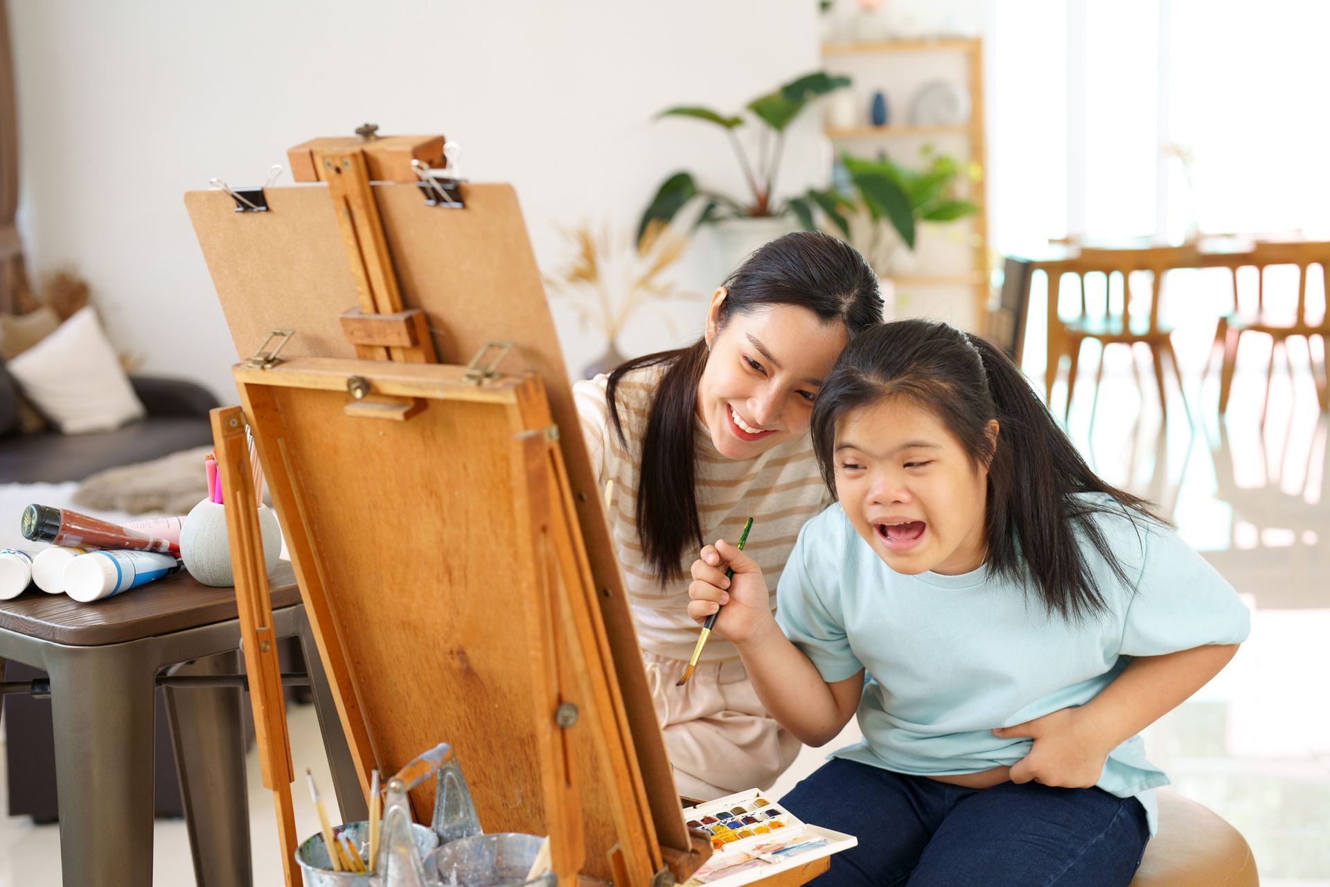 Happy Child Painting with Mother for Relaxation — Redcliffe, QLD — Achieve Disability Supports