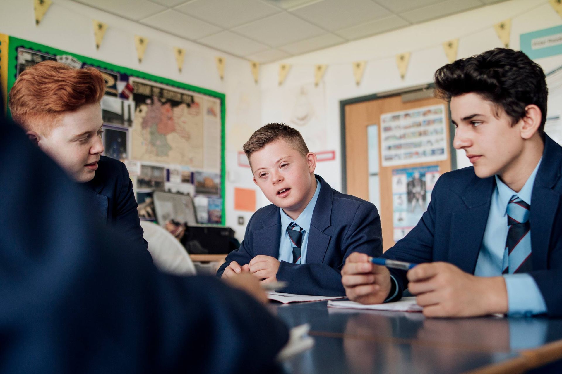 Group of teenage males discussing during class — Redcliffe, QLD — Achieve Disability Supports