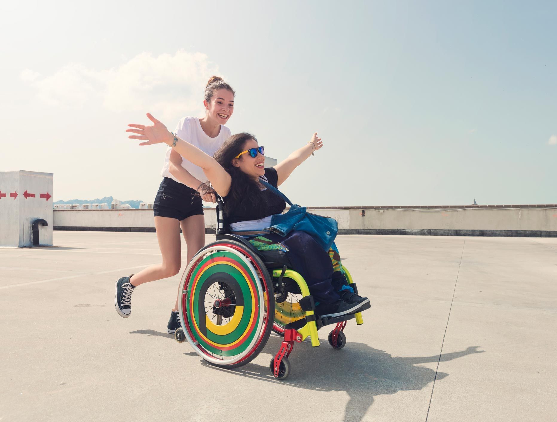 A young woman and her disabled friend in a wheelchair — Redcliffe, QLD — Achieve Disability Supports