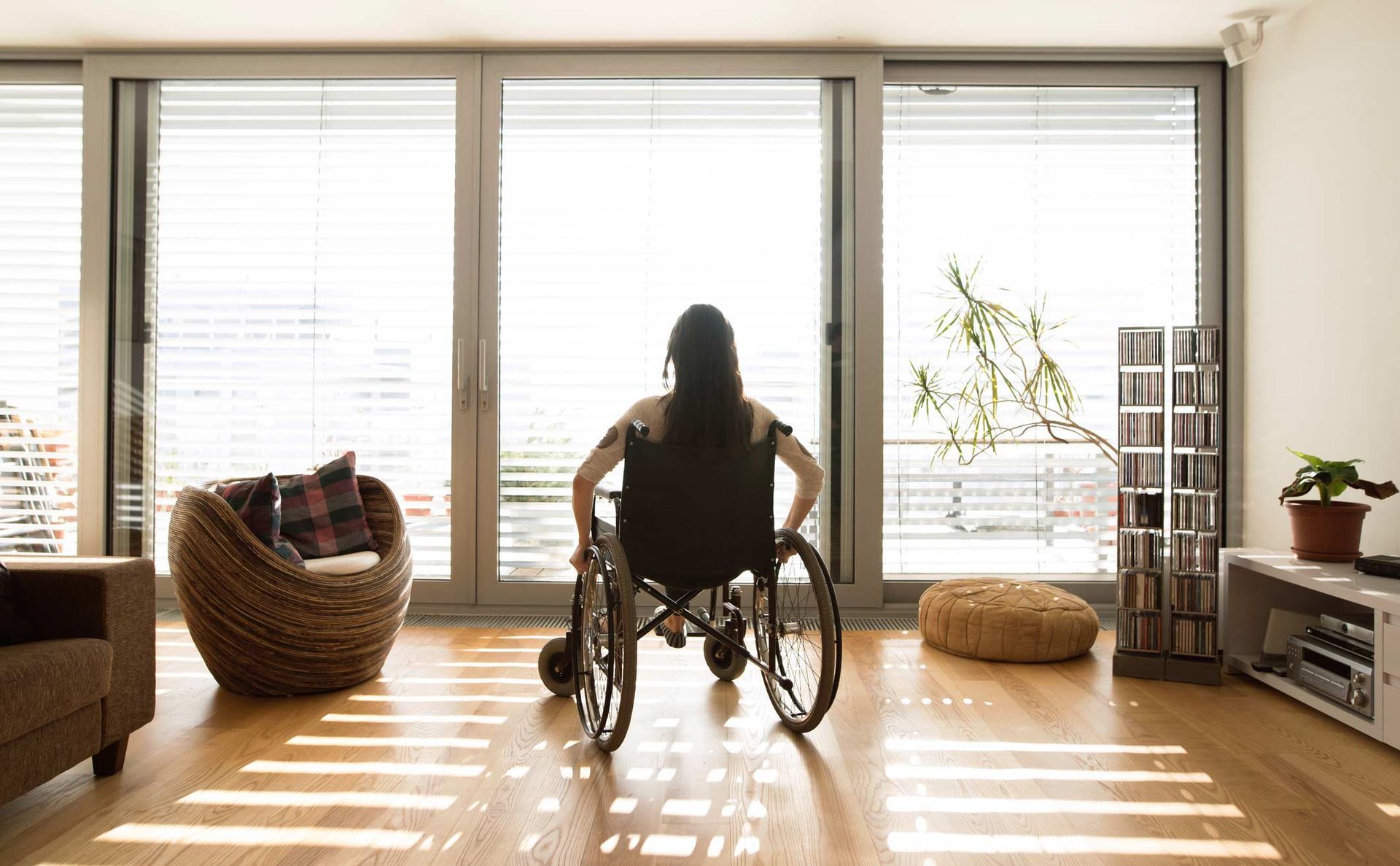 Young disabled woman in wheelchair at home — Redcliffe, QLD — Achieve Disability Supports