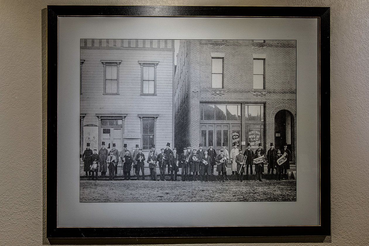 A black and white photo of a group of people standing in front of a building.