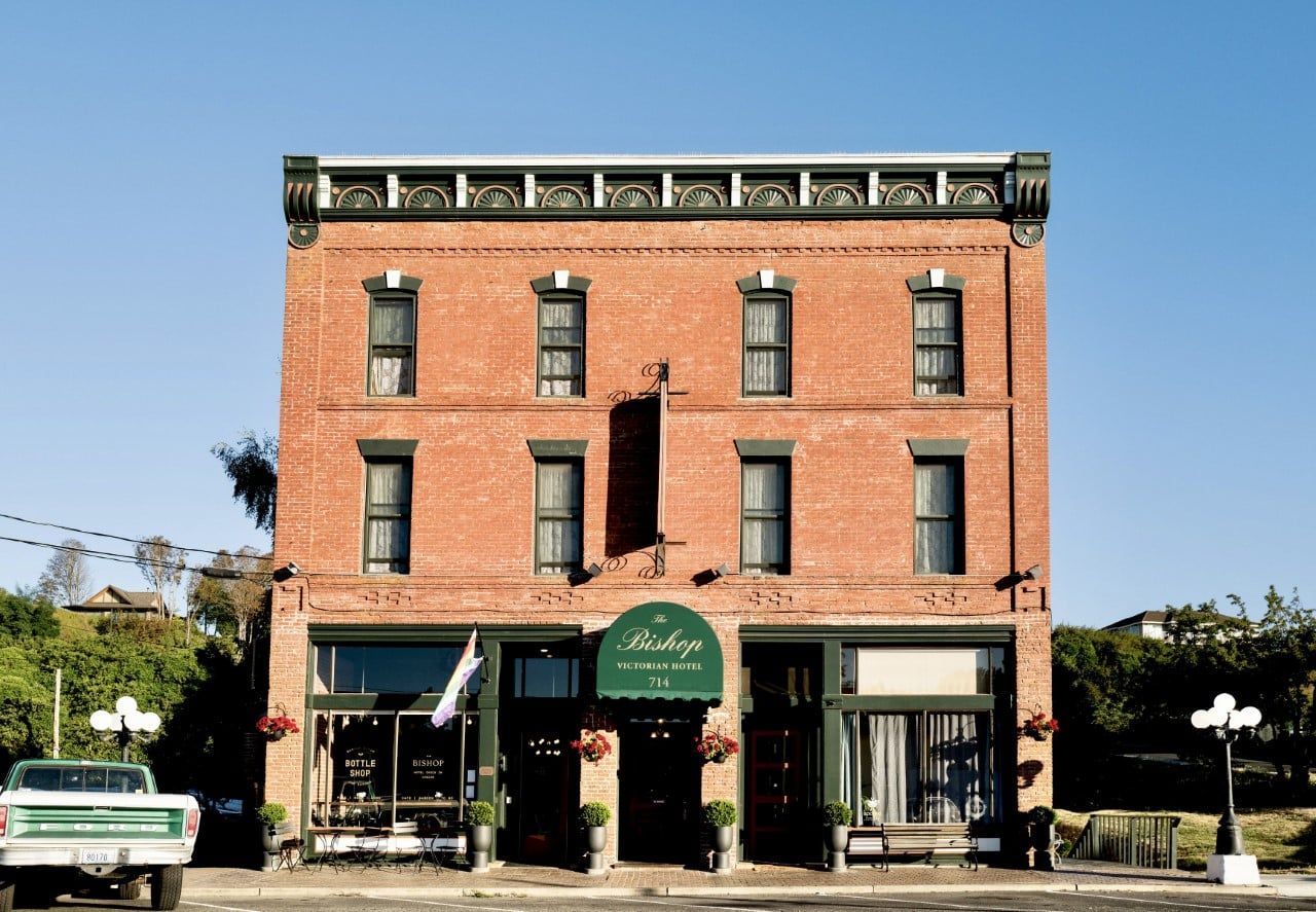 A brick building with a green awning that says ' bakery ' on it
