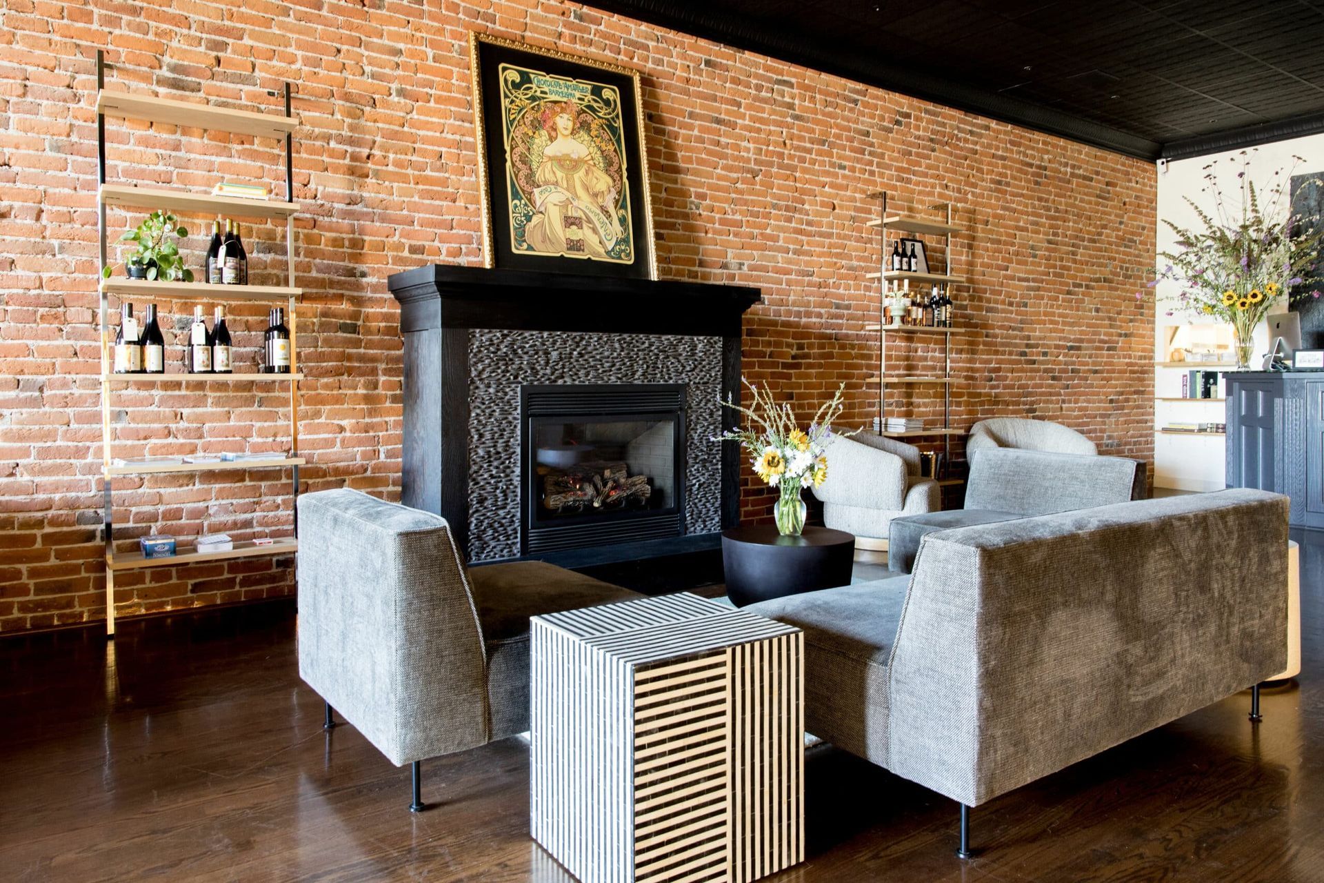 A living room with a fireplace and a brick wall