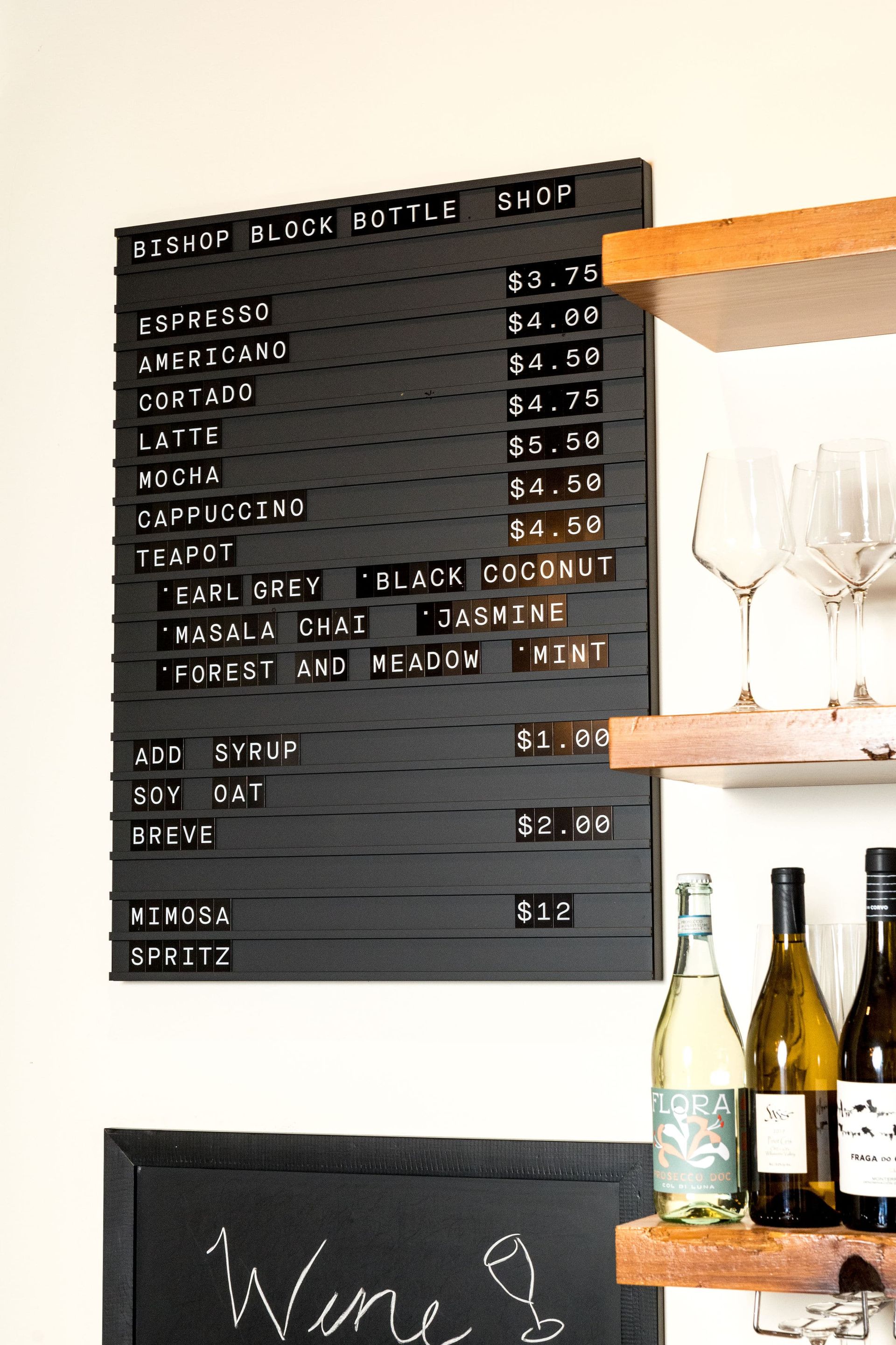 A blackboard with a menu on it is hanging on a wall.