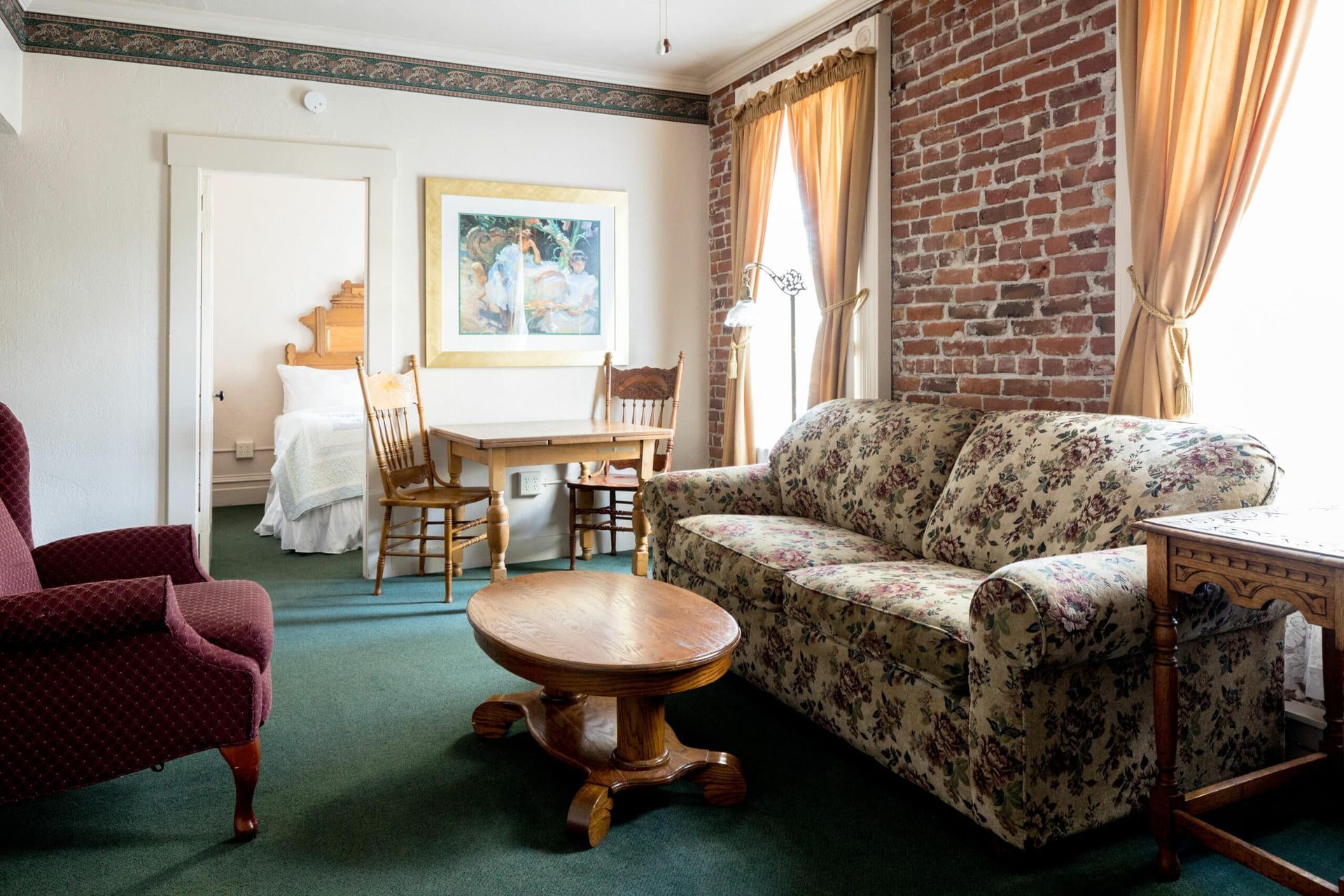 A living room with a couch and chairs and a table