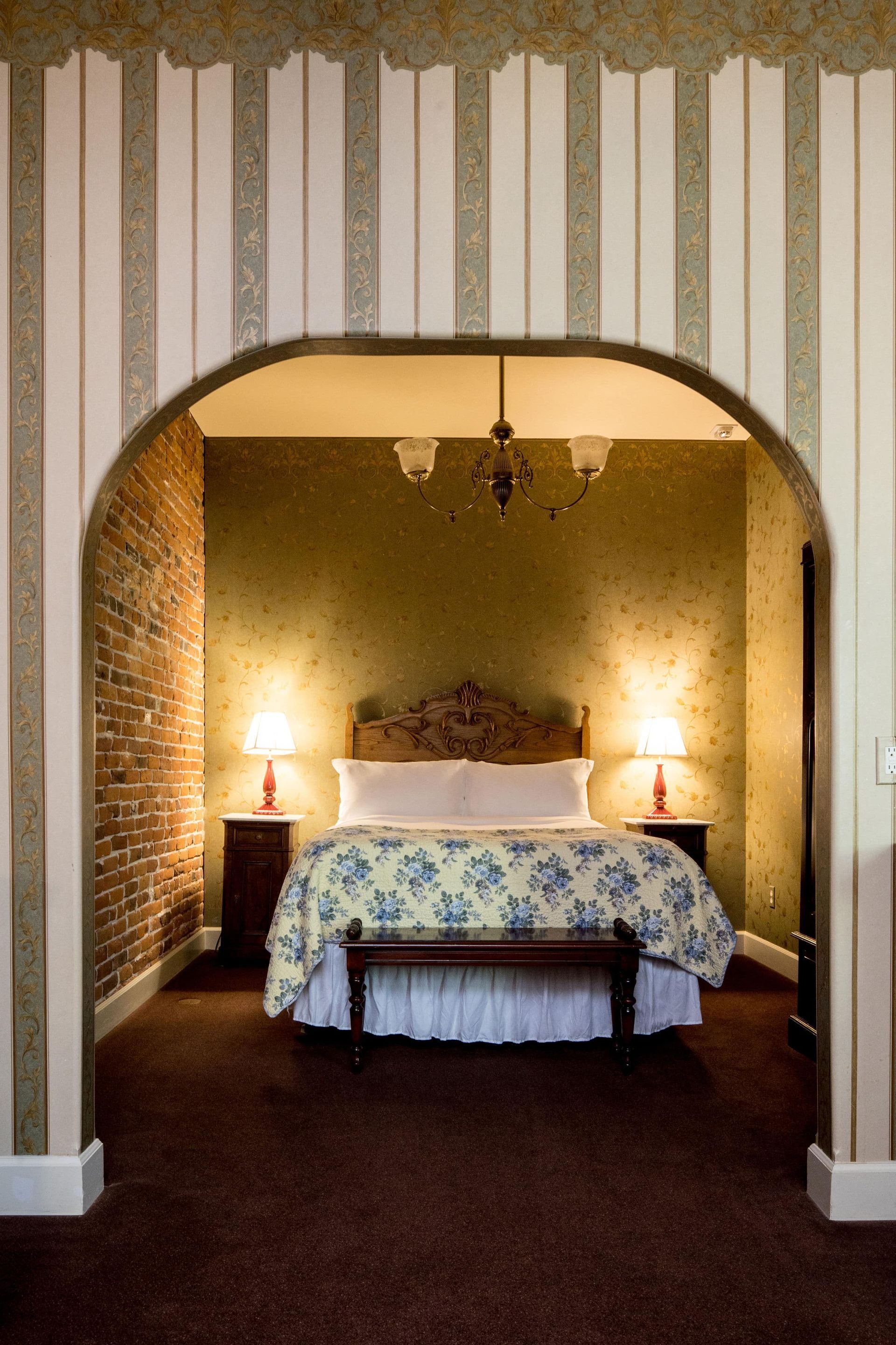 A bedroom with a bed and a bench in it