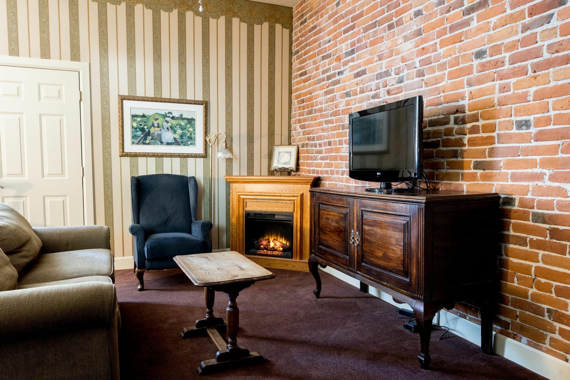 A living room with a fireplace and a flat screen tv