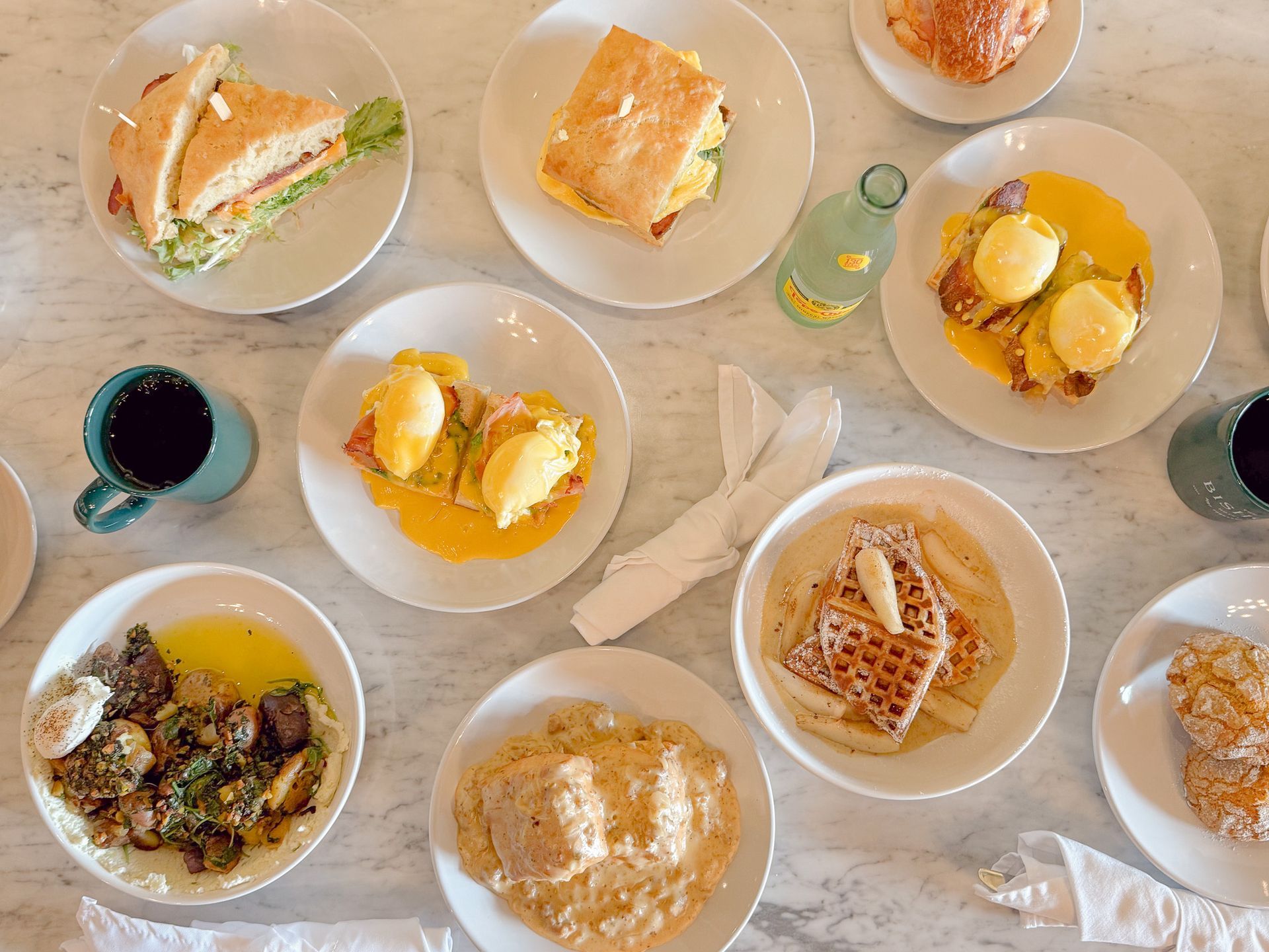 A restaurant with tables and chairs in front of a large window.