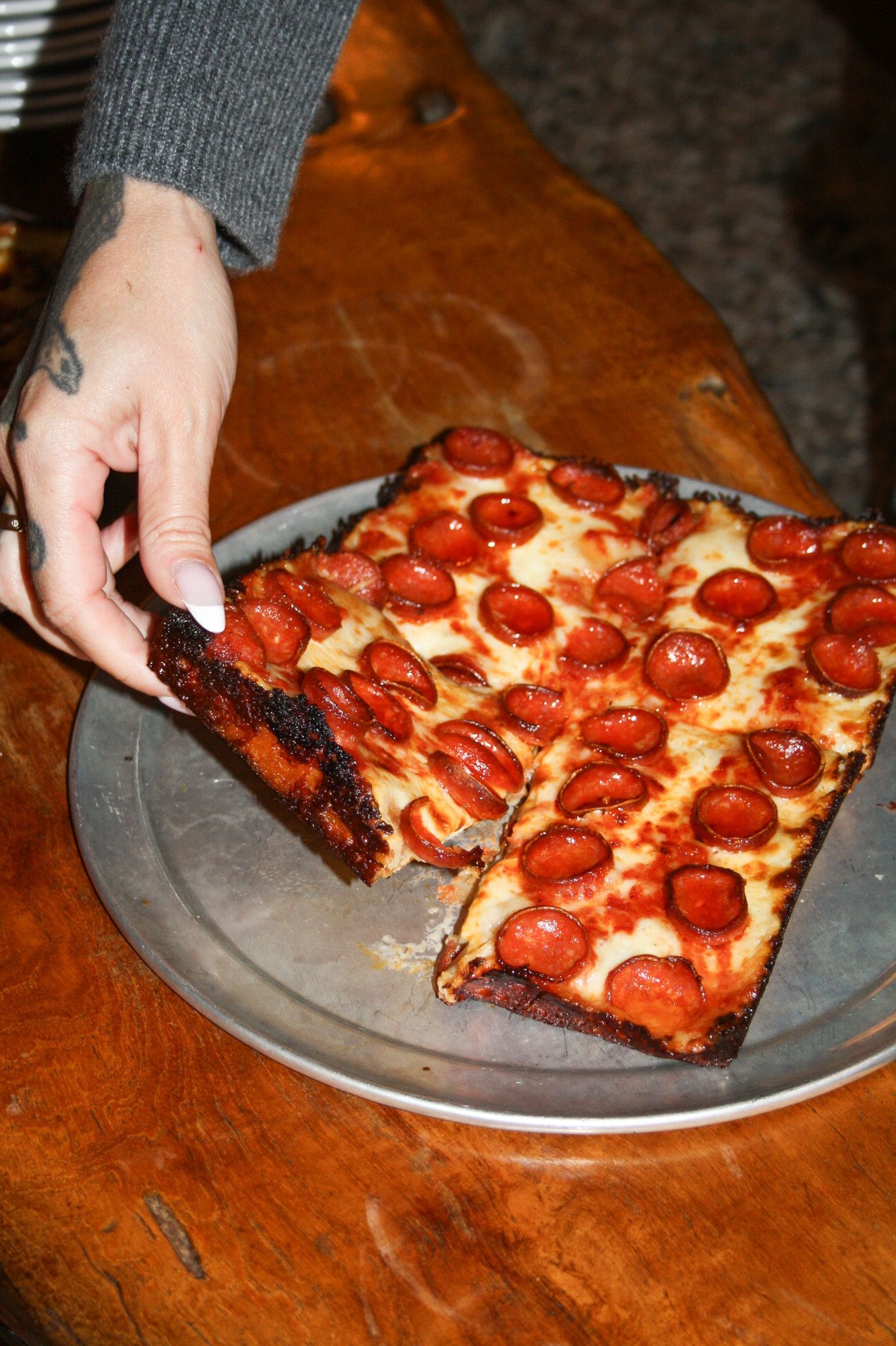 A plate of chips and a bowl of dip on a table
