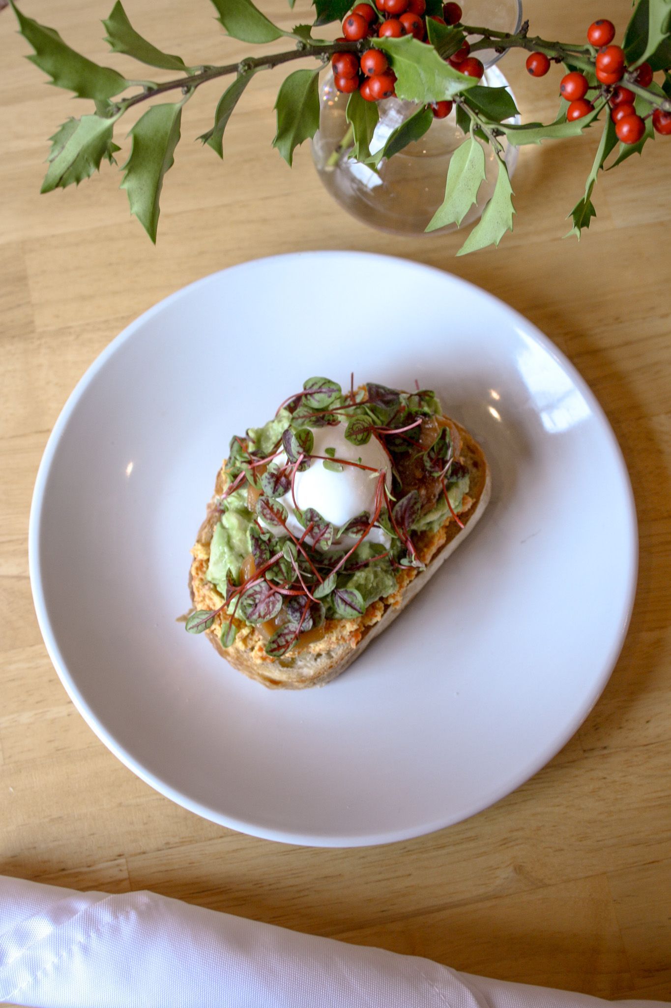 A group of people are dancing at a wedding reception under a string of lights.
